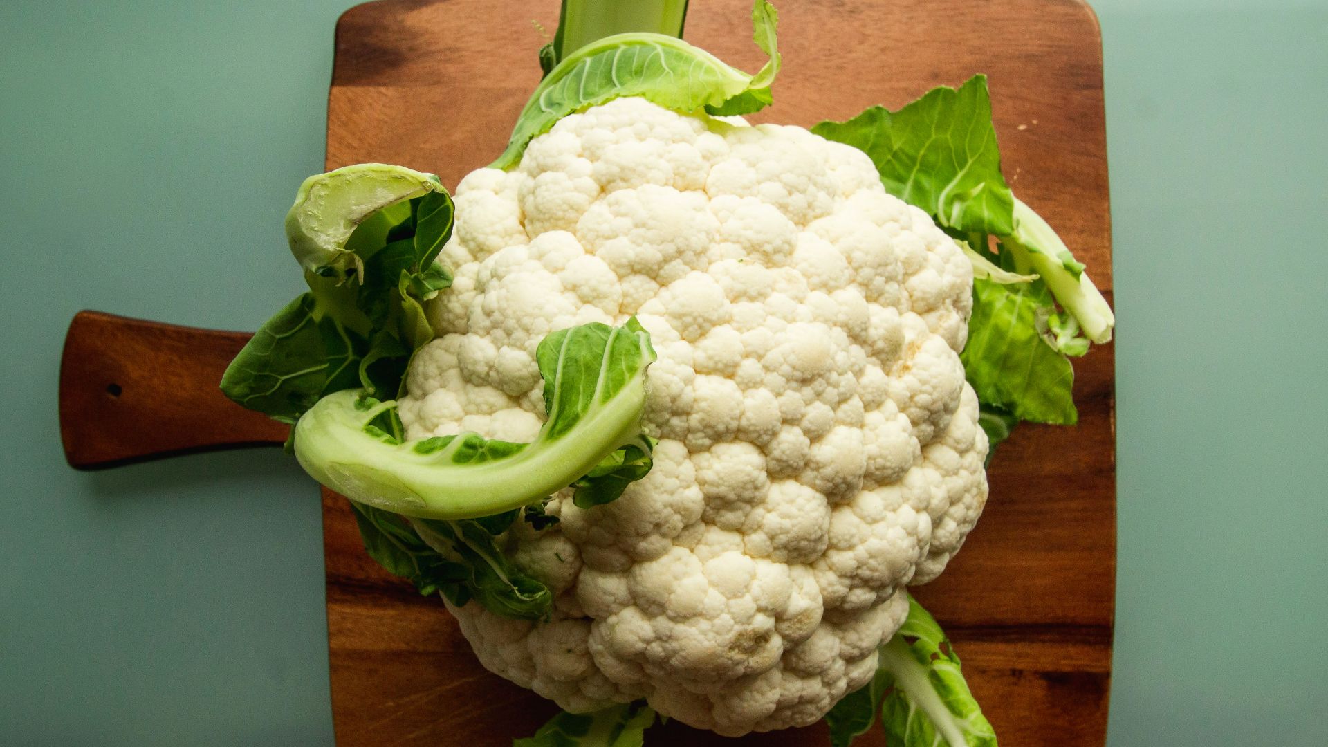 white cauliflower on brown wooden chopping board