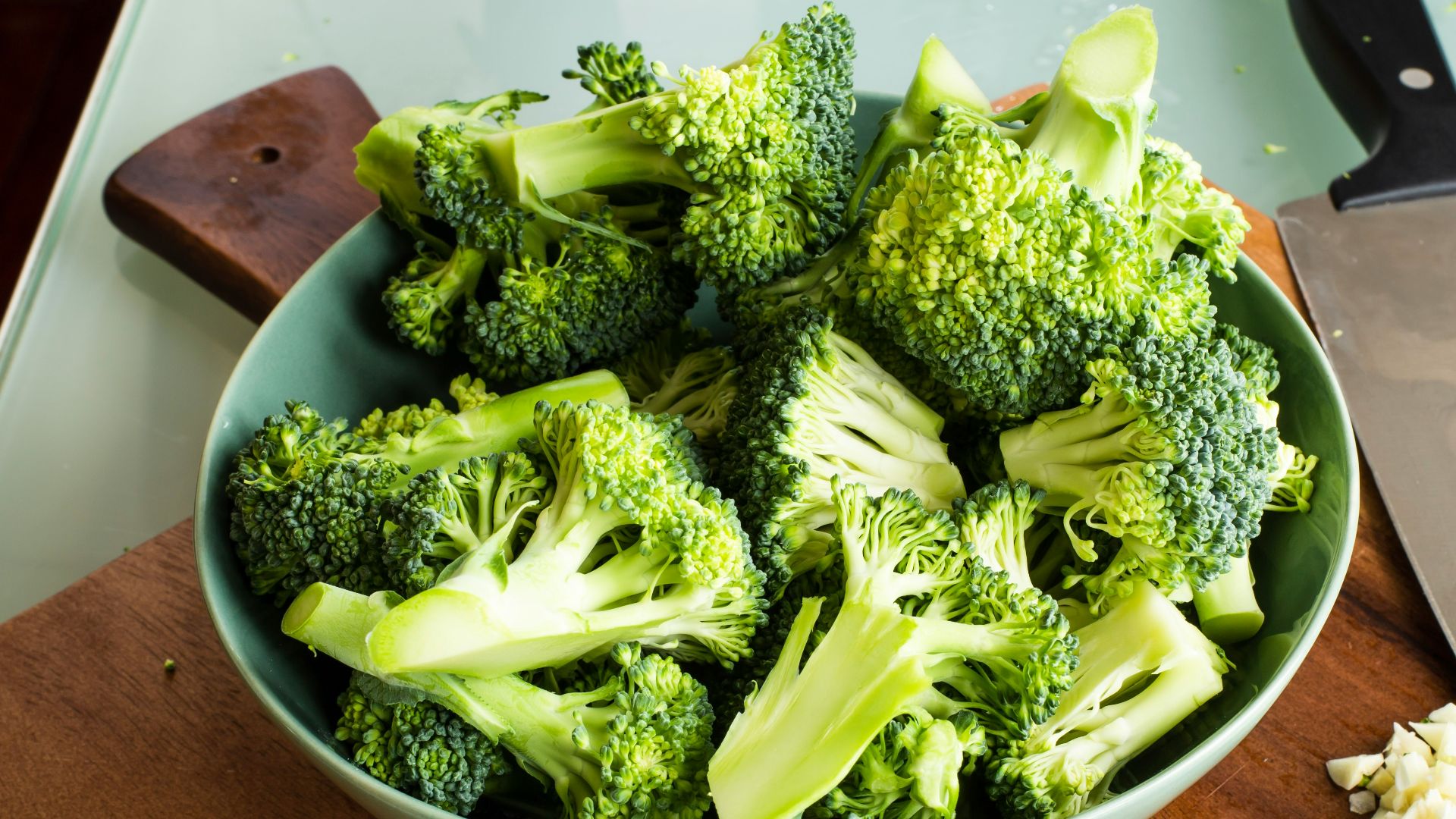 green broccoli on brown wooden chopping board