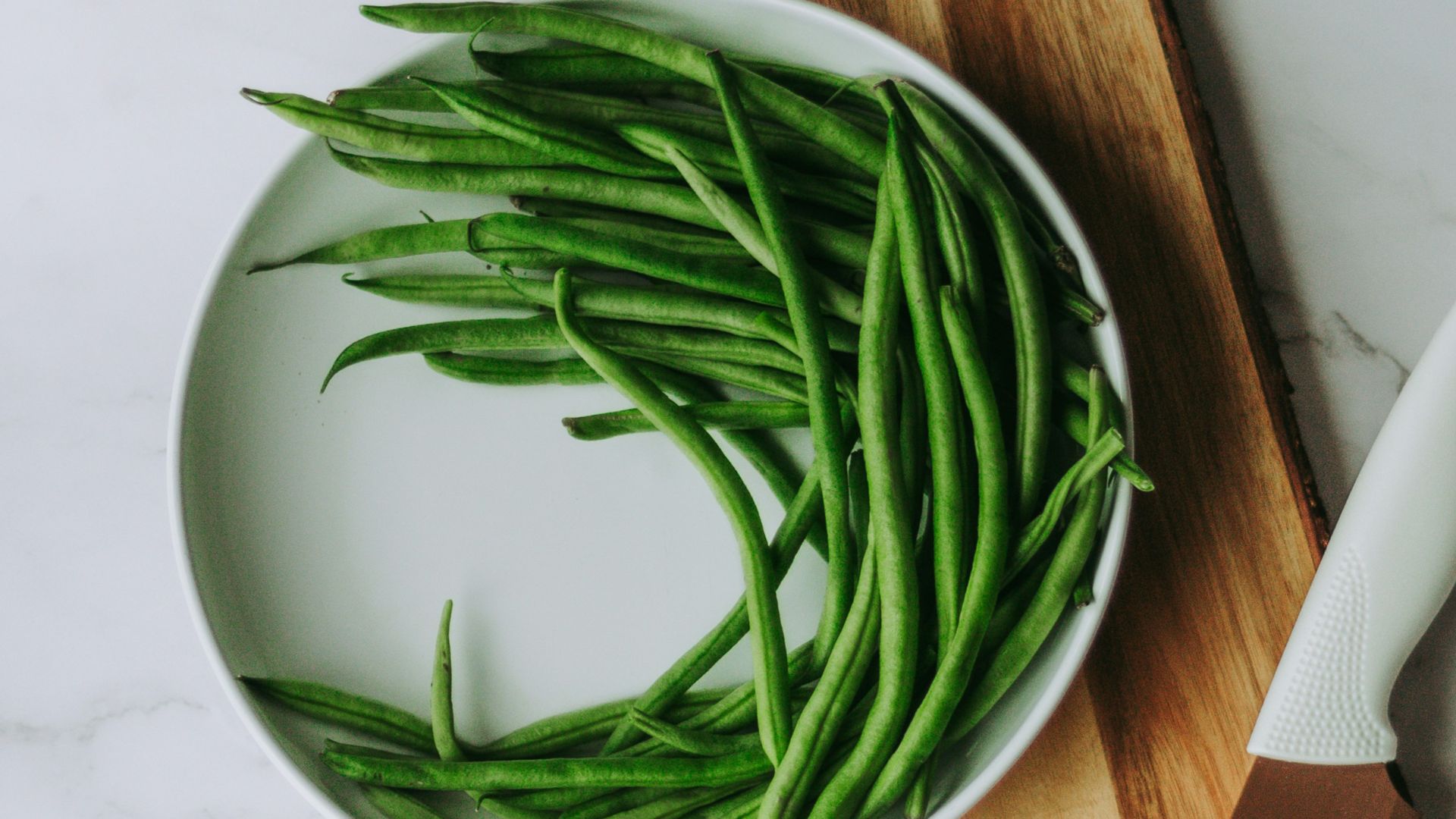 green and white vegetable on brown wooden chopping board