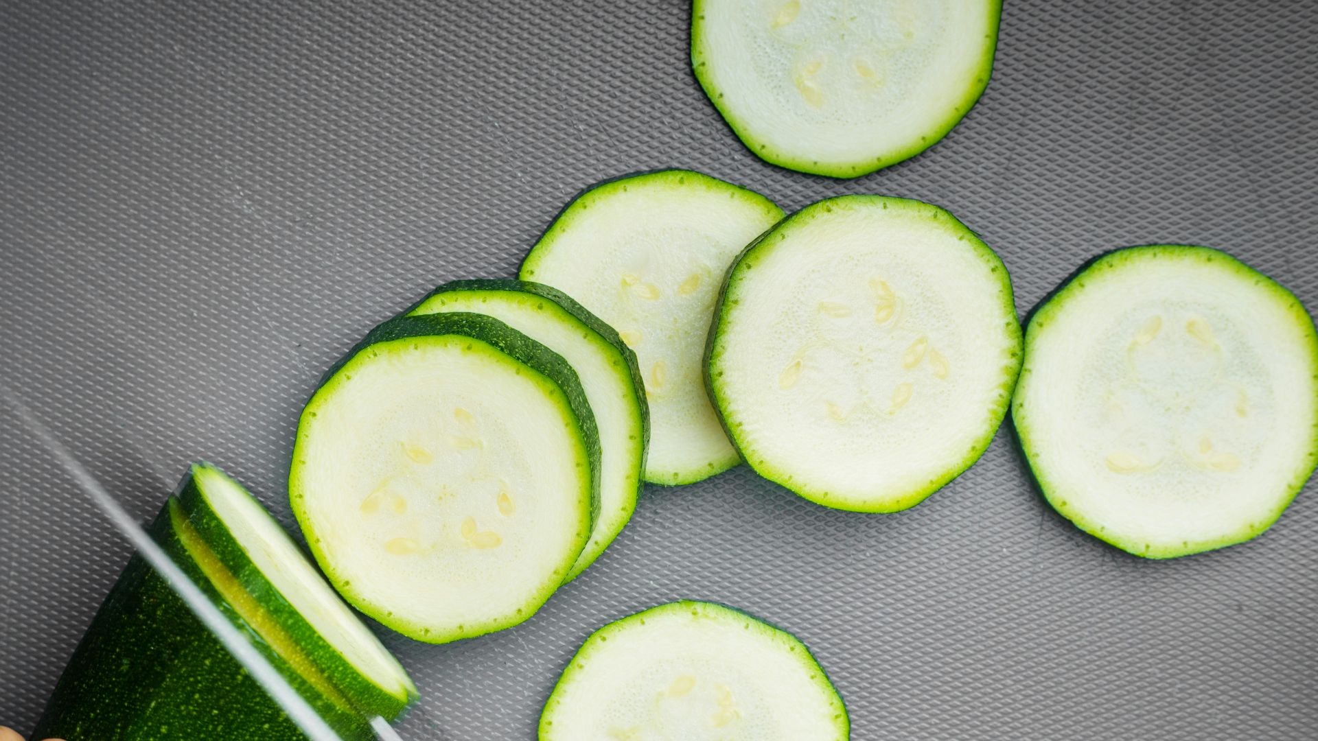 sliced cucumber on black textile