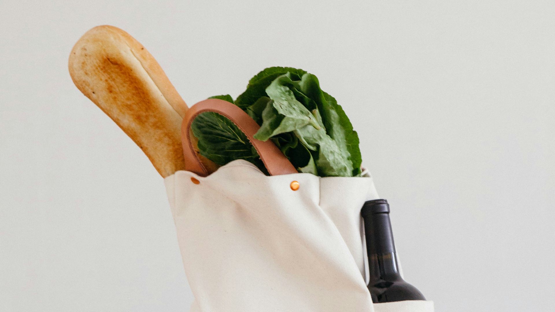 brown wooden rolling pin beside white paper bag