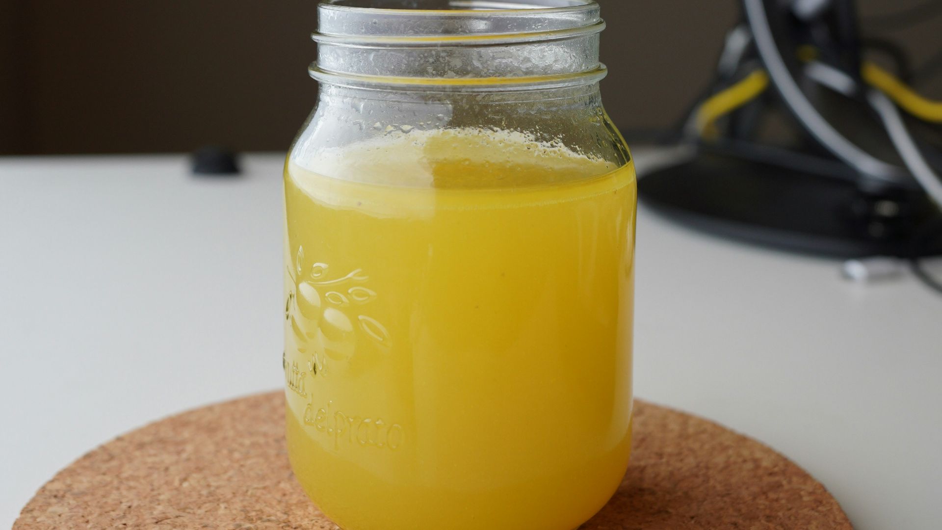 clear glass jar with yellow liquid inside