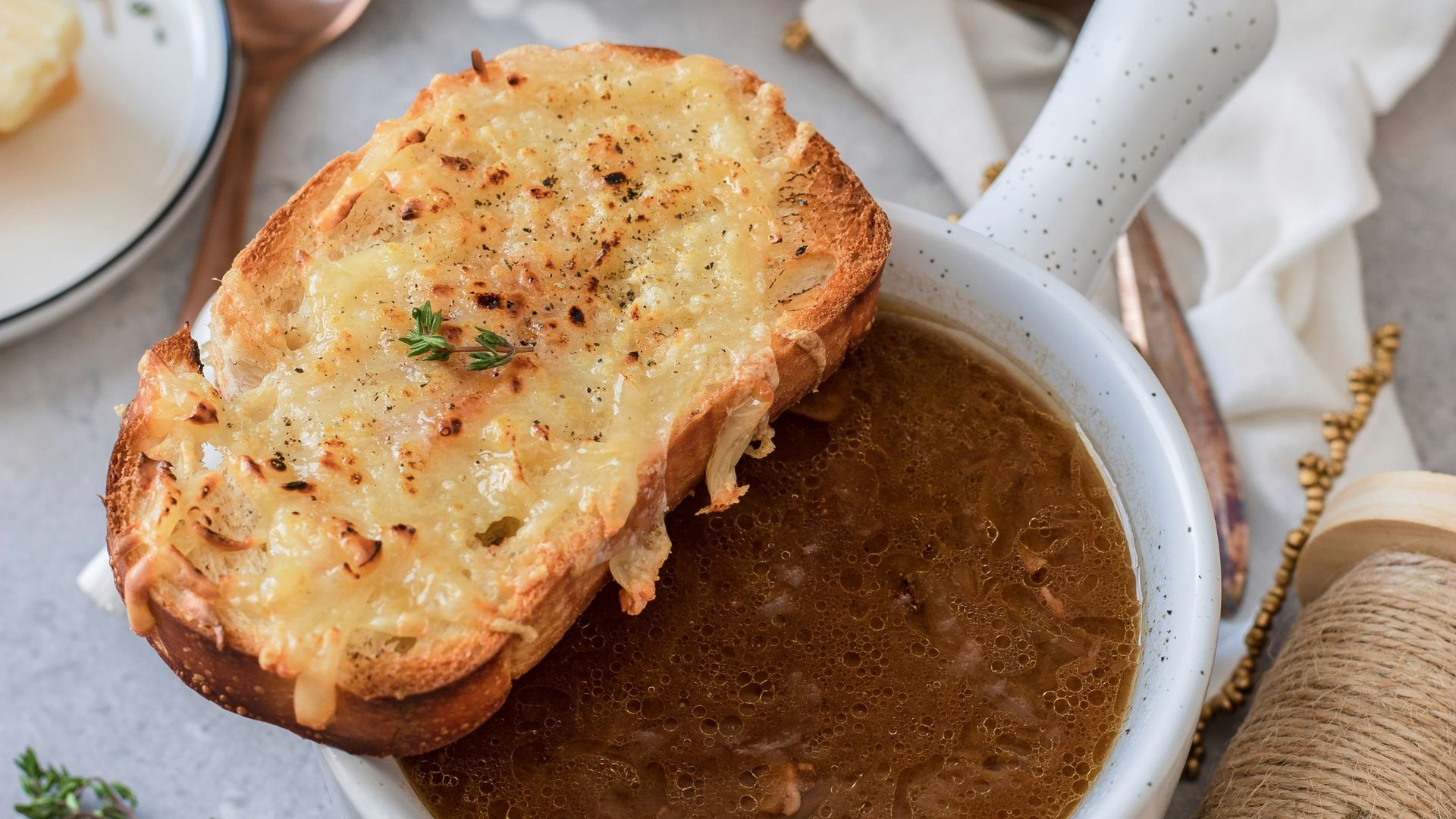 toasted breads on white ceramic bowl with brown soup