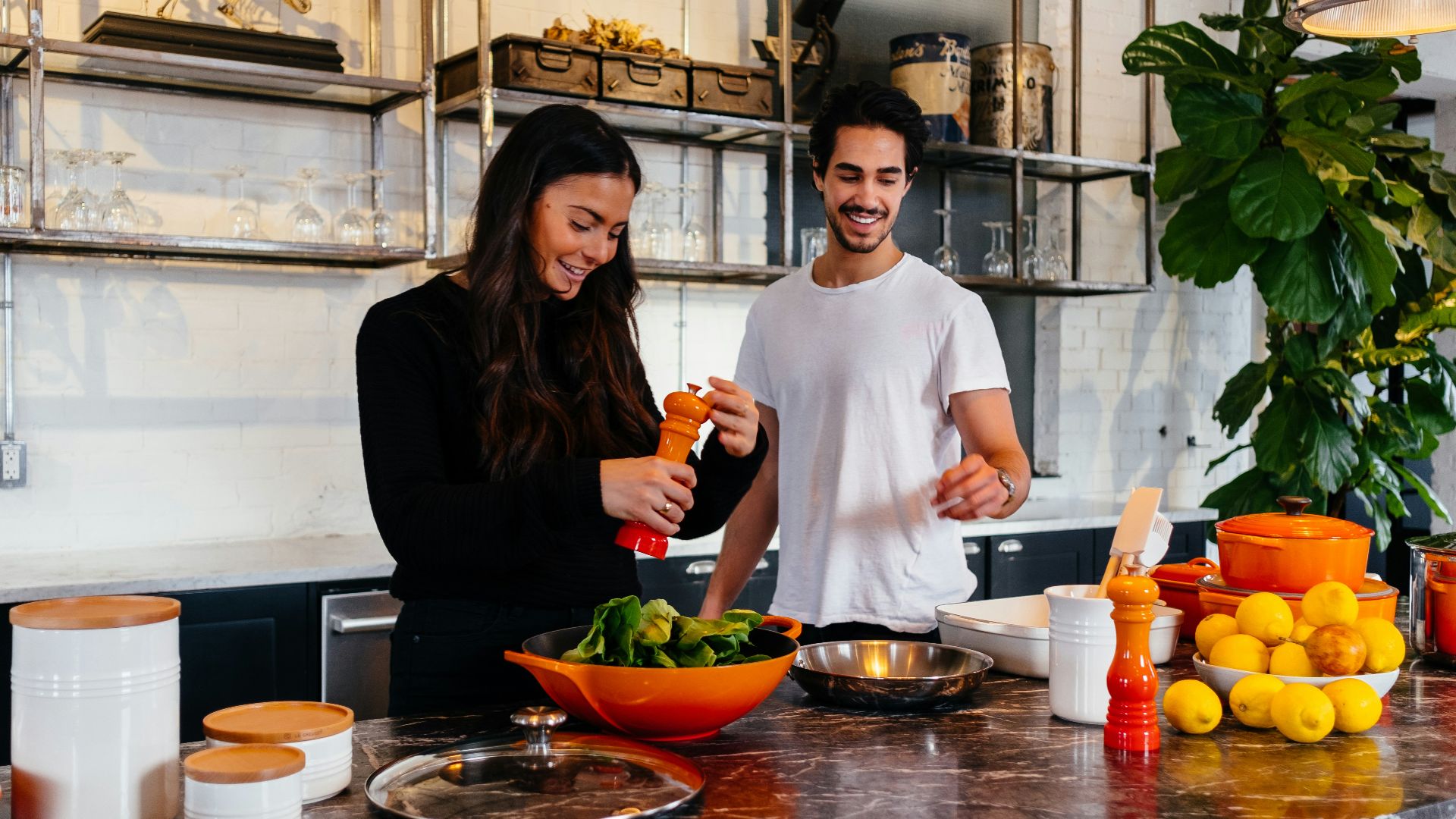 man and woman standing in front of table