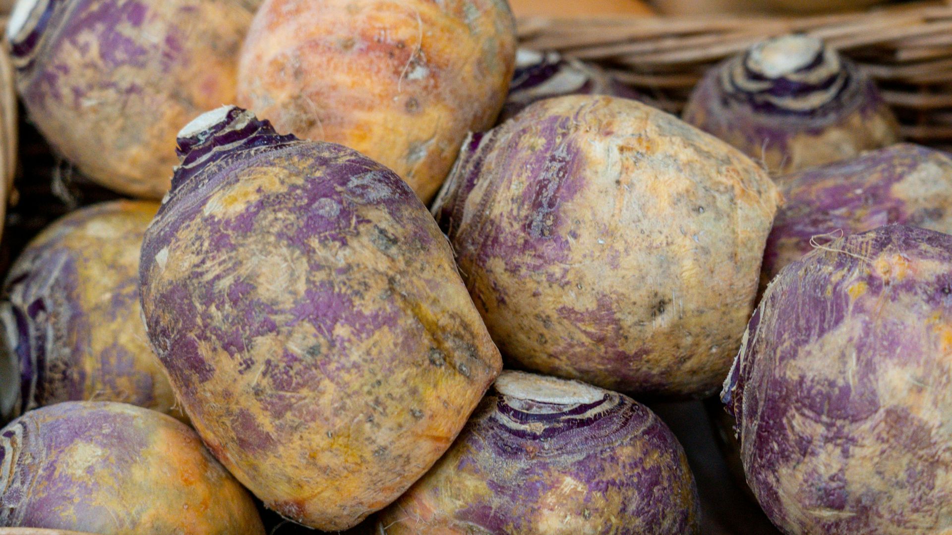 a basket filled with purple potatoes sitting on top of a table