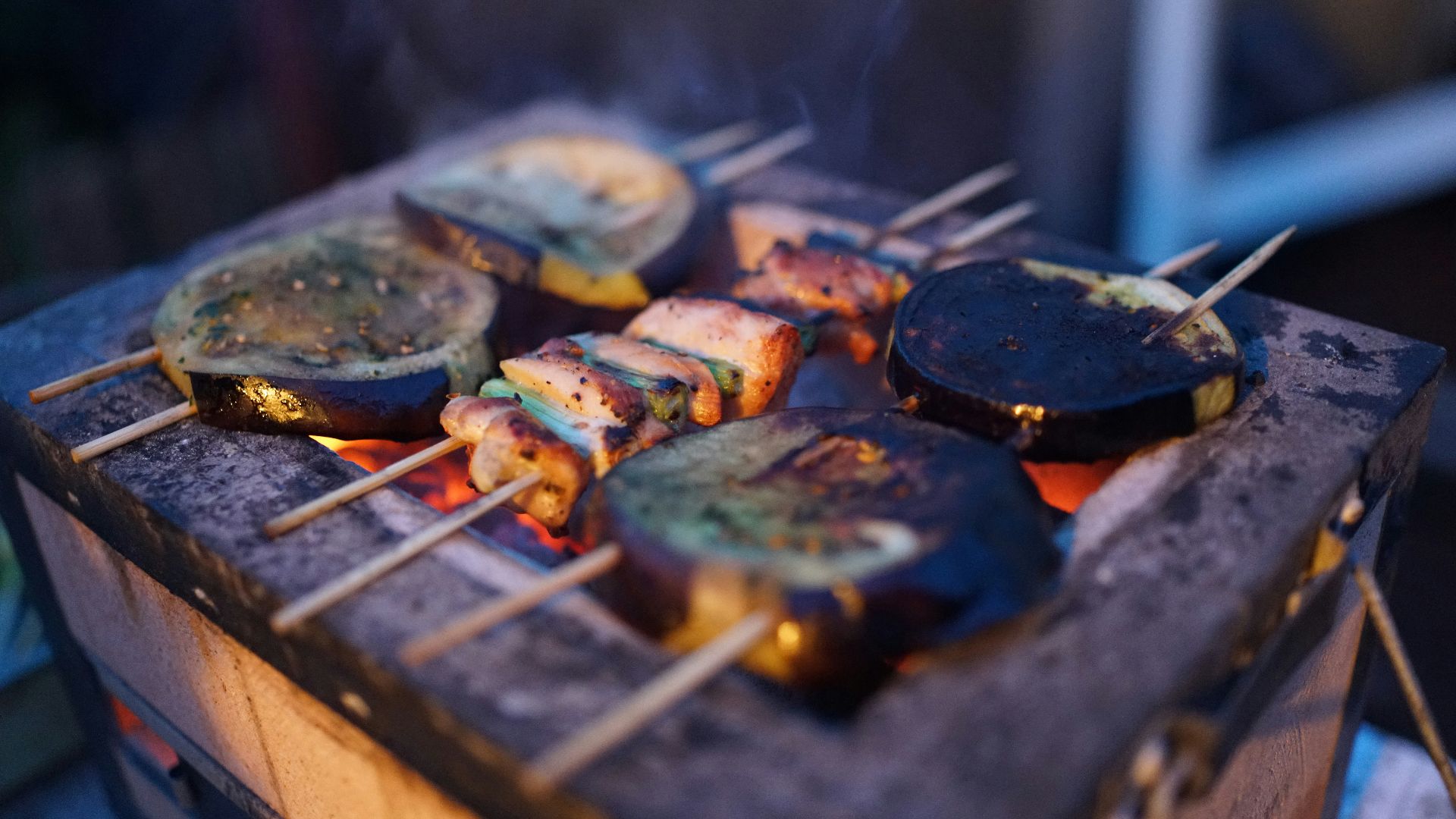 three assorted barbeques on black grill