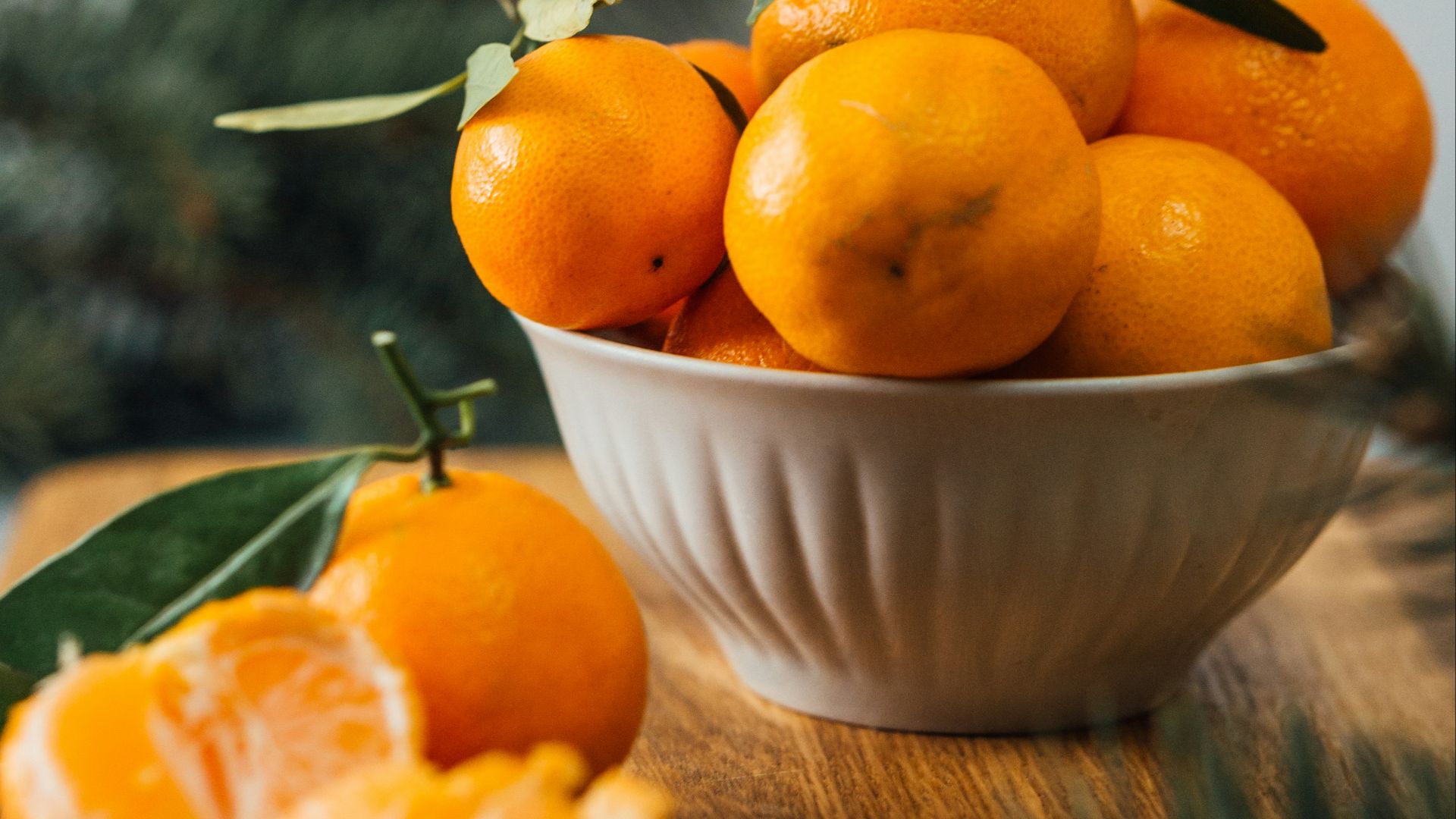 orange fruits in white ceramic bowl