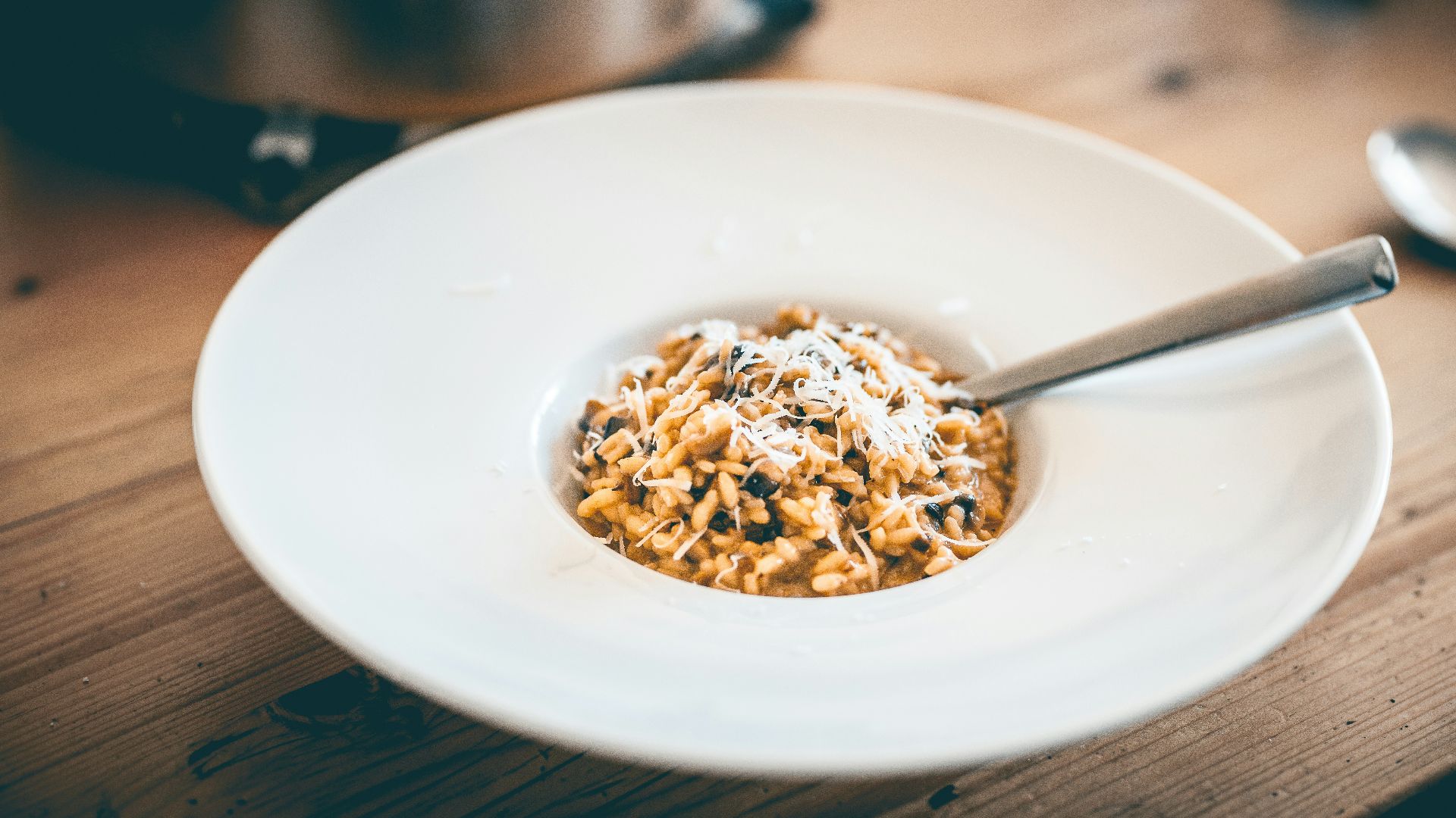 a bowl of food on a wooden table