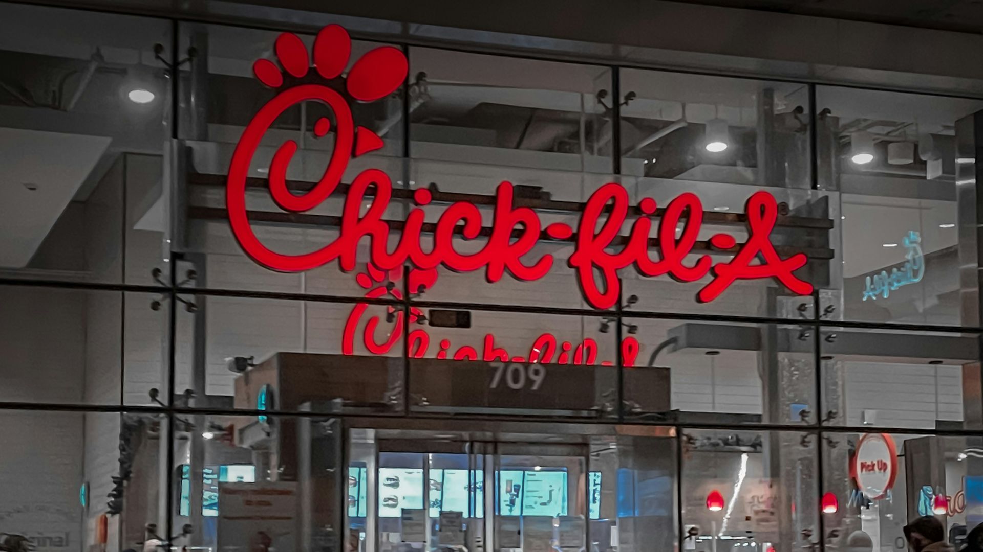 a store front with people walking by