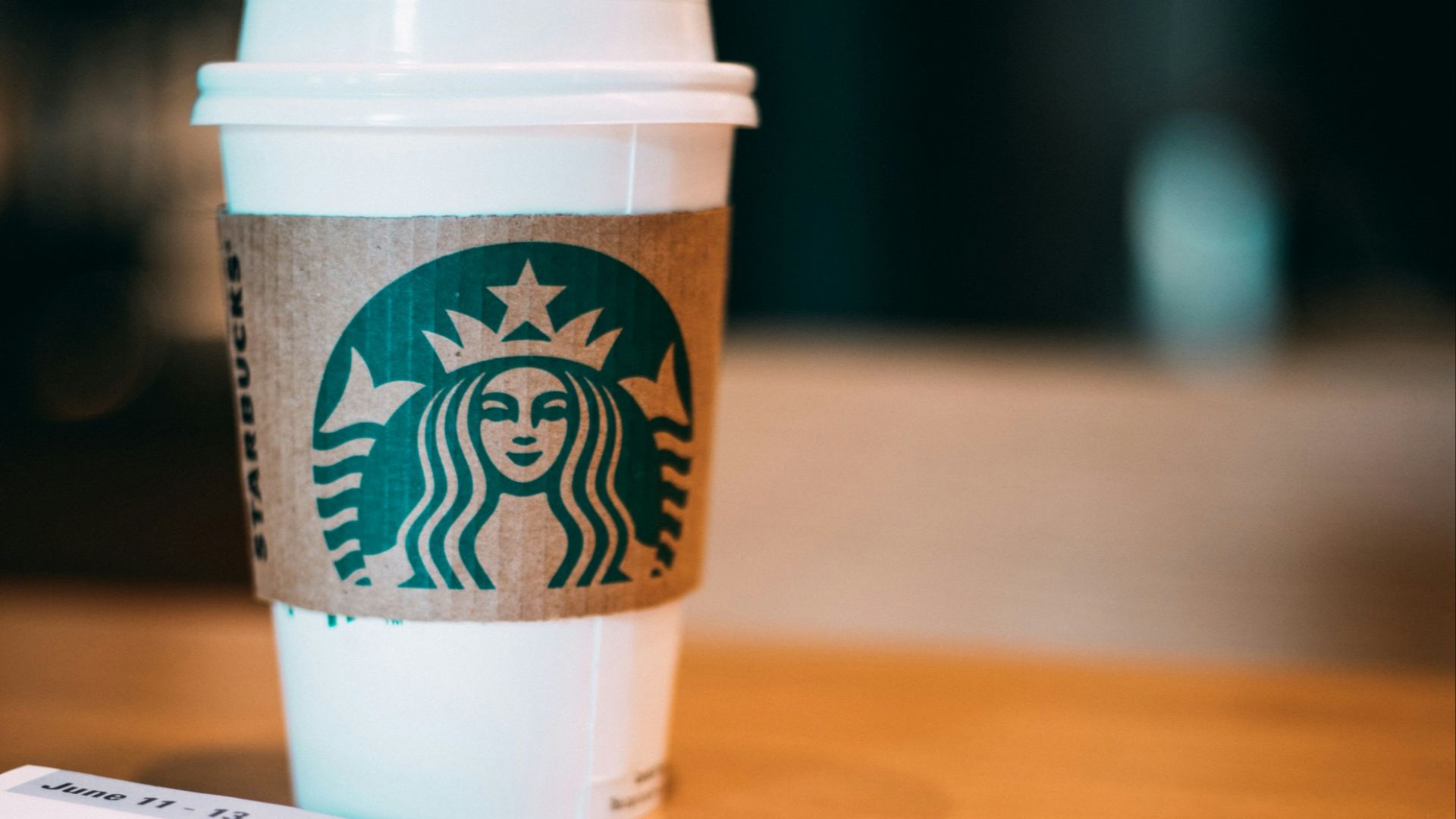 selective focus photography of Starbucks coffee cup