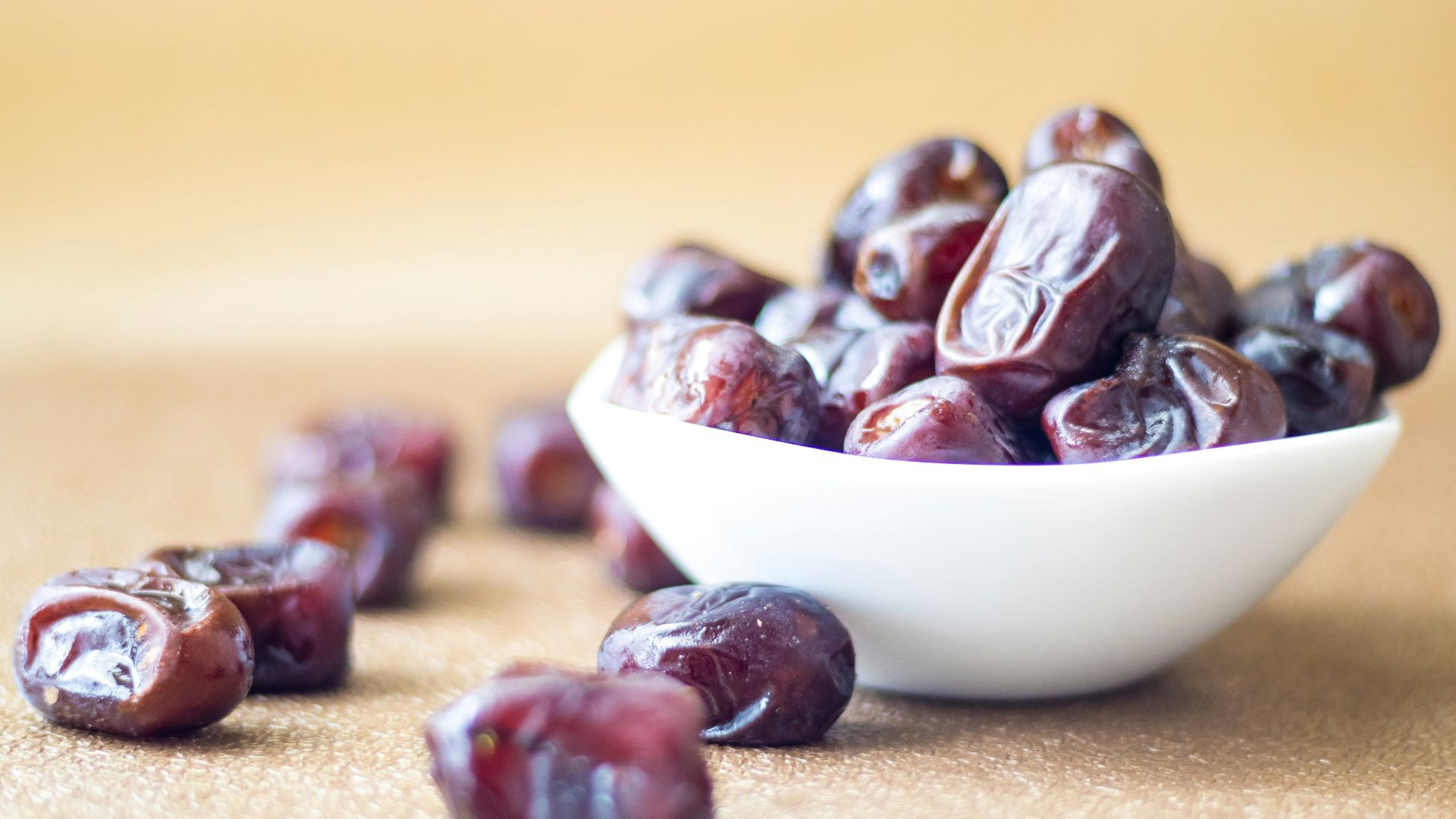 brown round fruit on white ceramic bowl