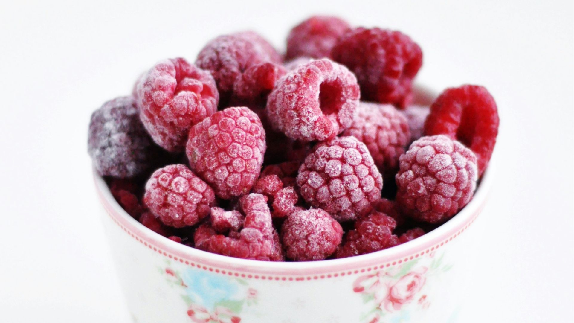 raspberry on white and pink floral ceramic cup