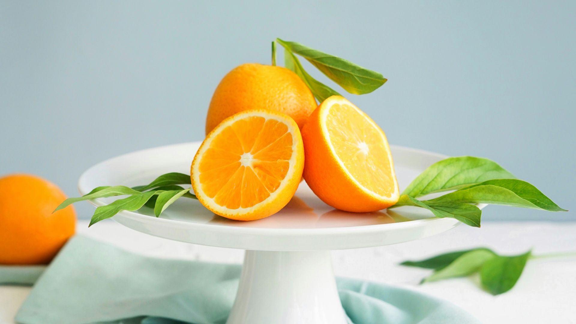 orange fruit in white ceramic plate close-up photography