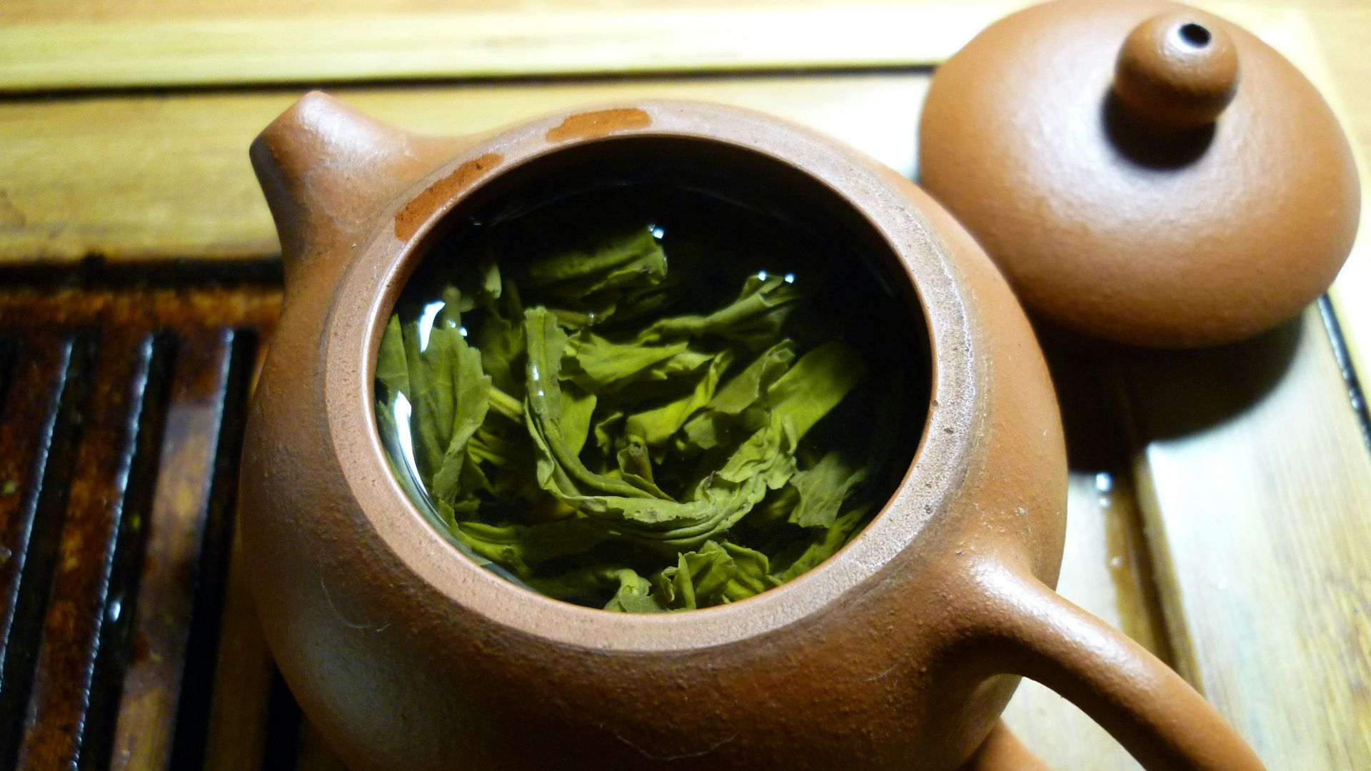 green leaves and clear liquid inside teapot