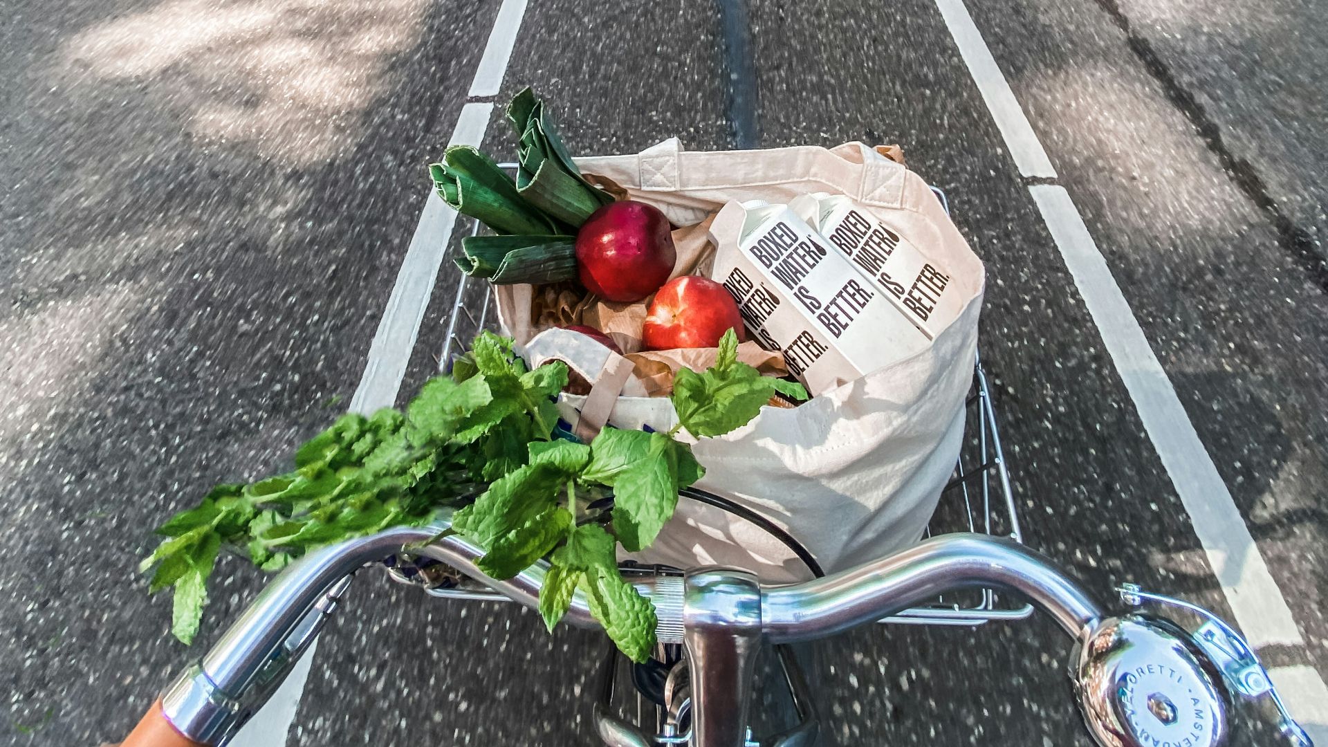 red roses in brown cardboard box on bicycle
