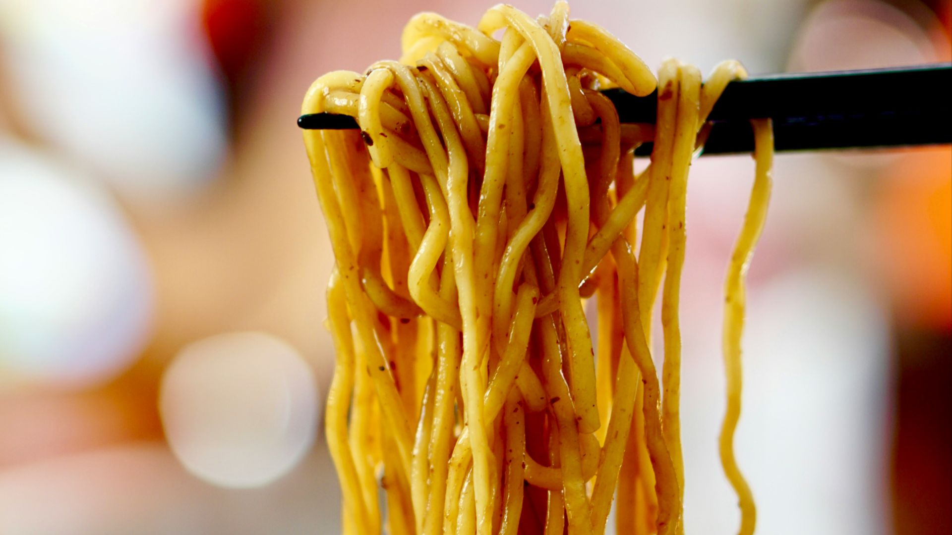 yellow pasta on blue and white ceramic bowl