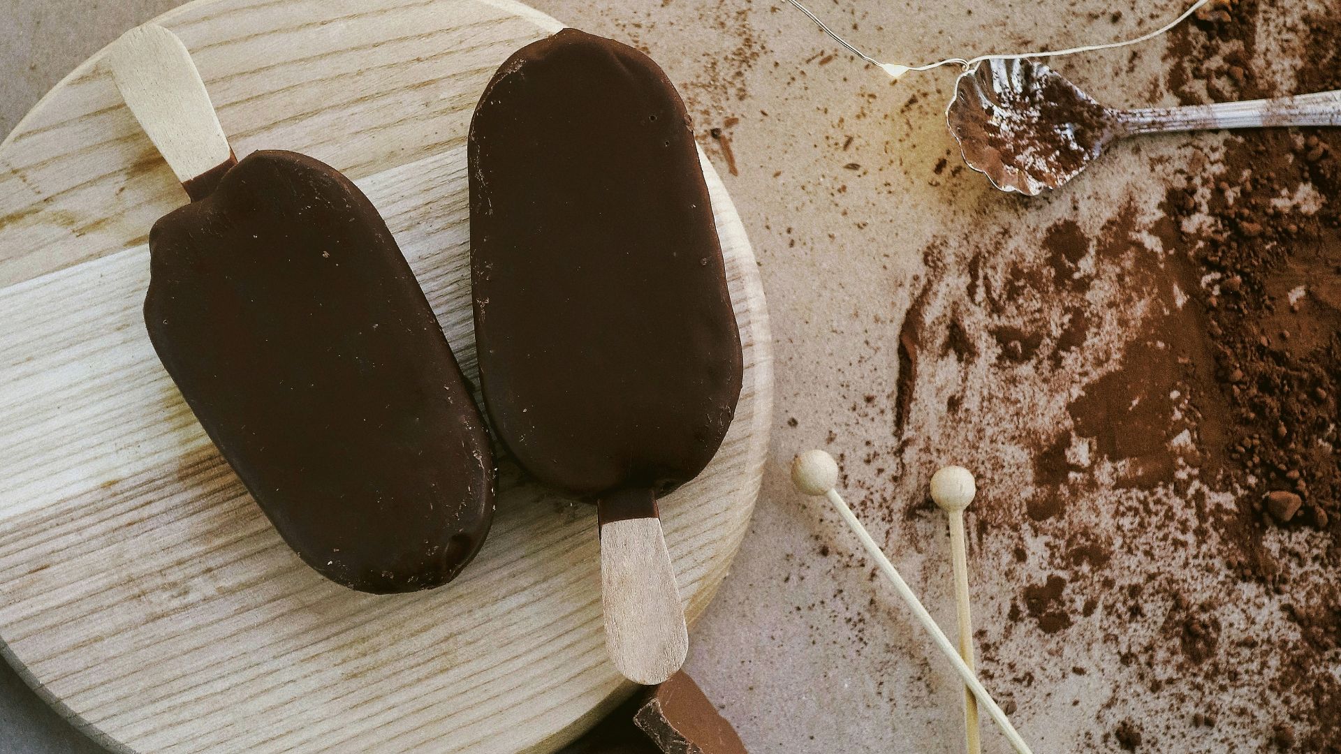 a wooden plate topped with ice cream and chocolate