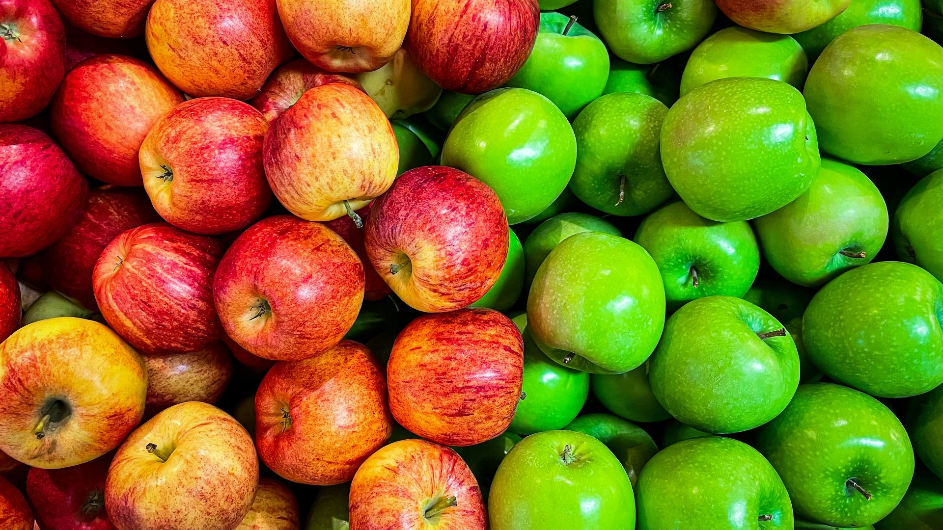 green and red apples on white plastic container