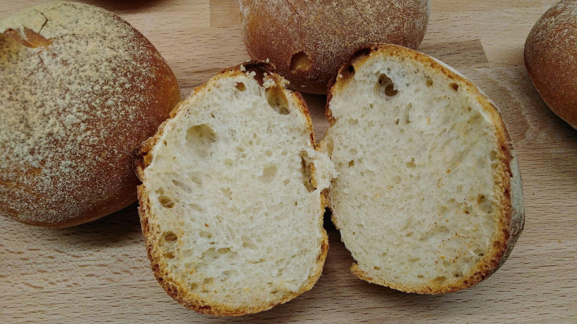 two brown bread on brown wooden table
