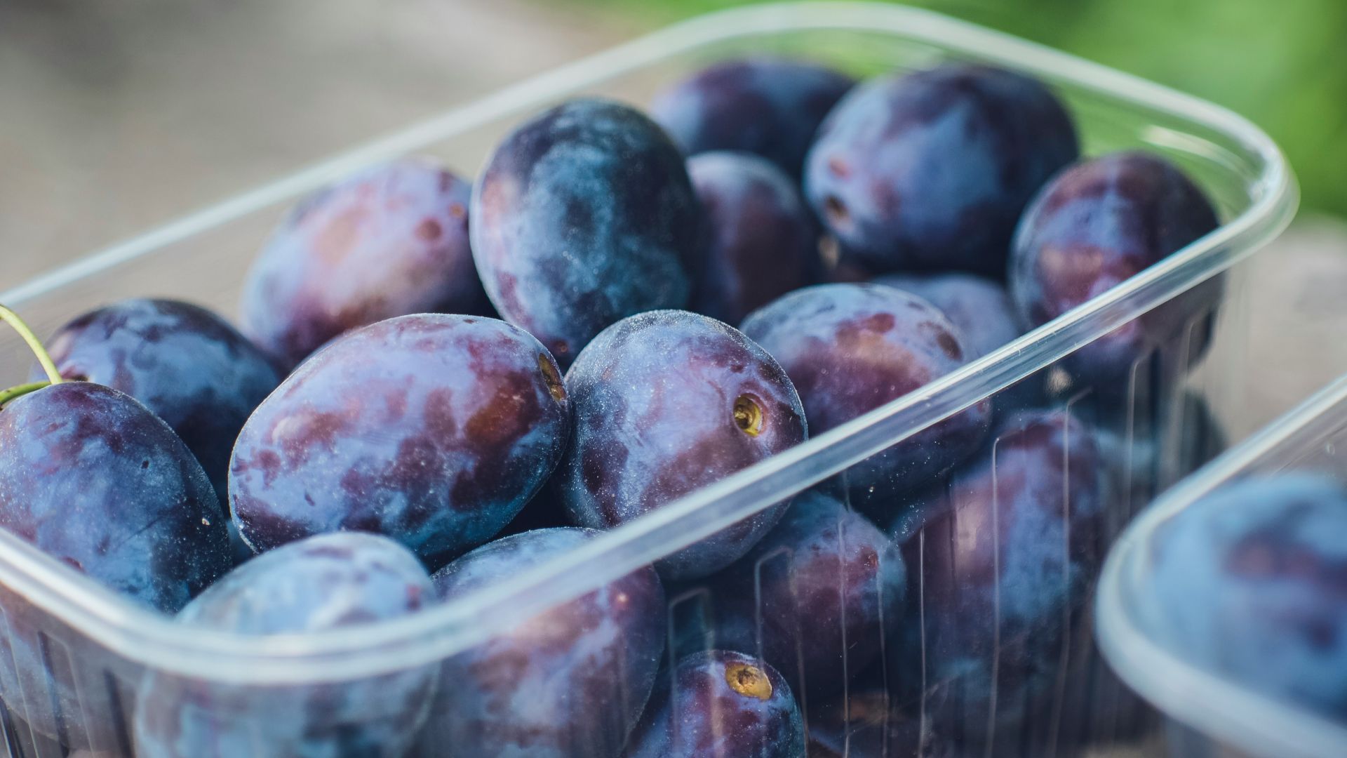 red round fruits on white plastic container
