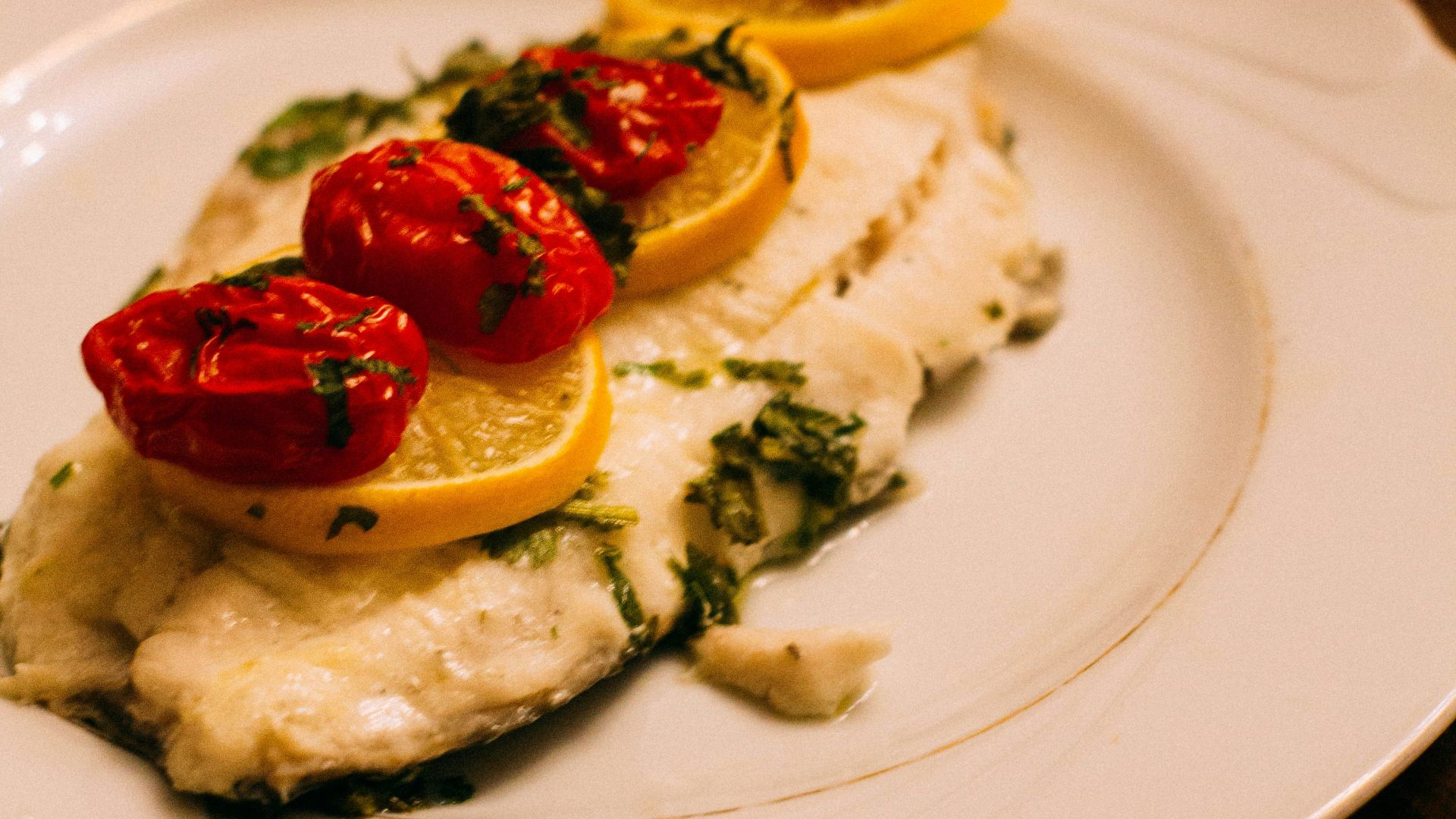 white and brown pastry with strawberry on top on white ceramic plate