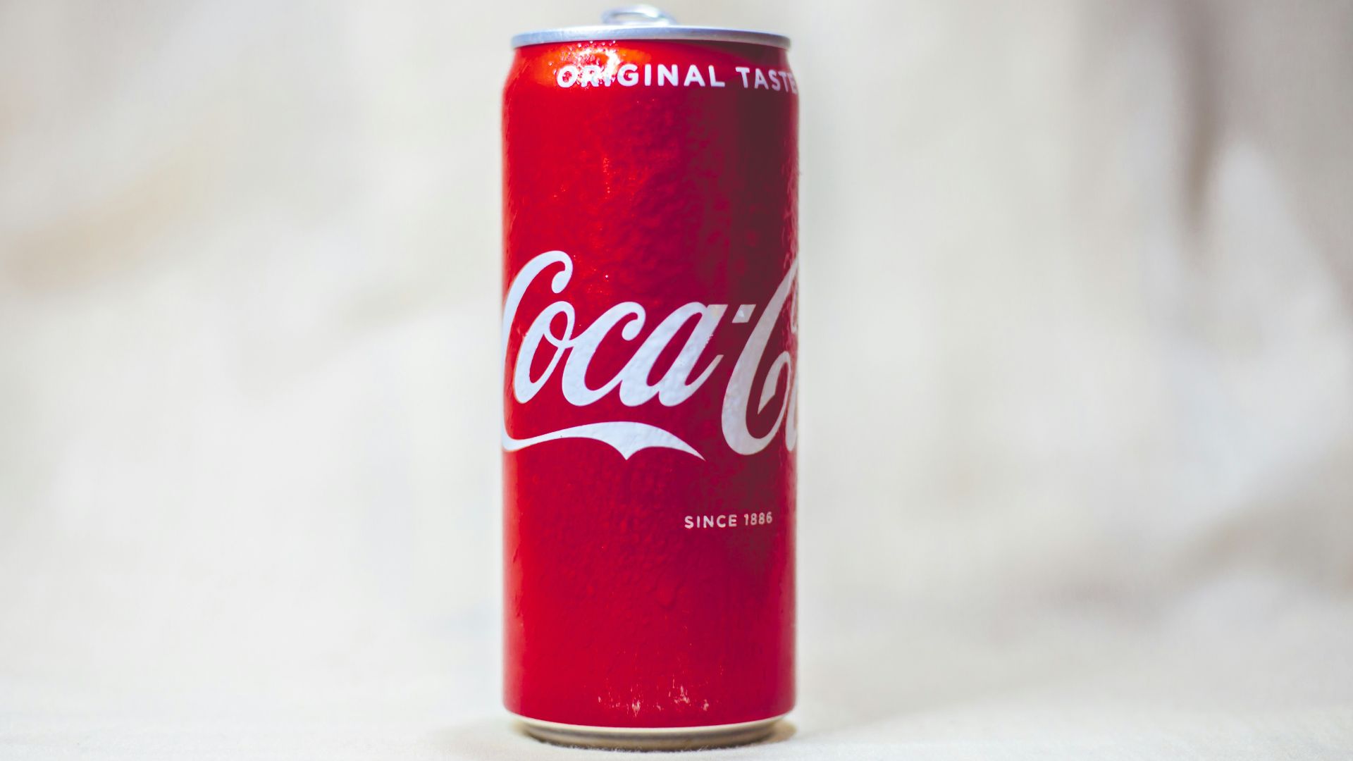 coca cola can on white table