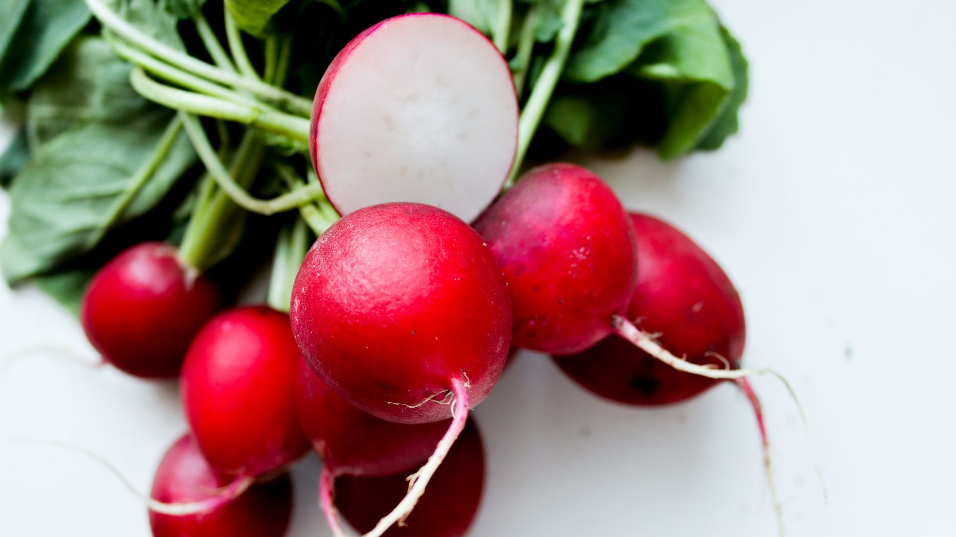 red tomato on white surface