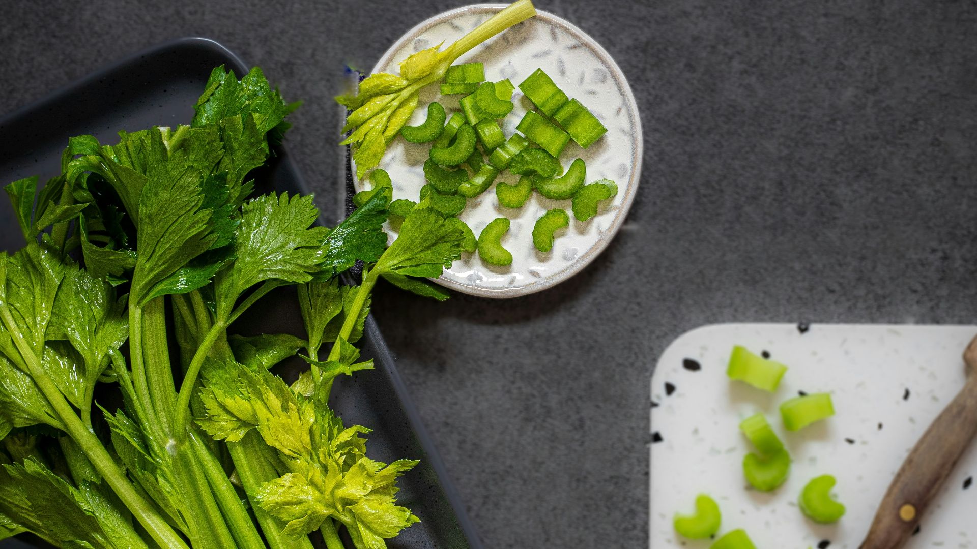 a cutting board with celery and a knife on it