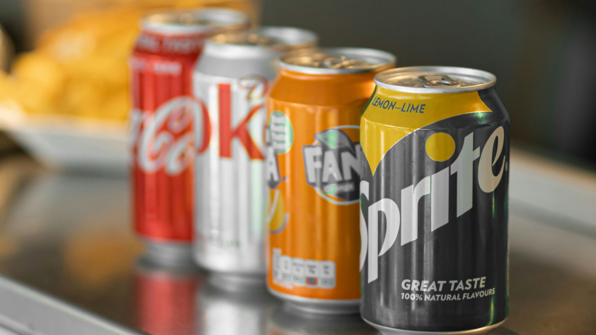 two coca cola cans on stainless steel table