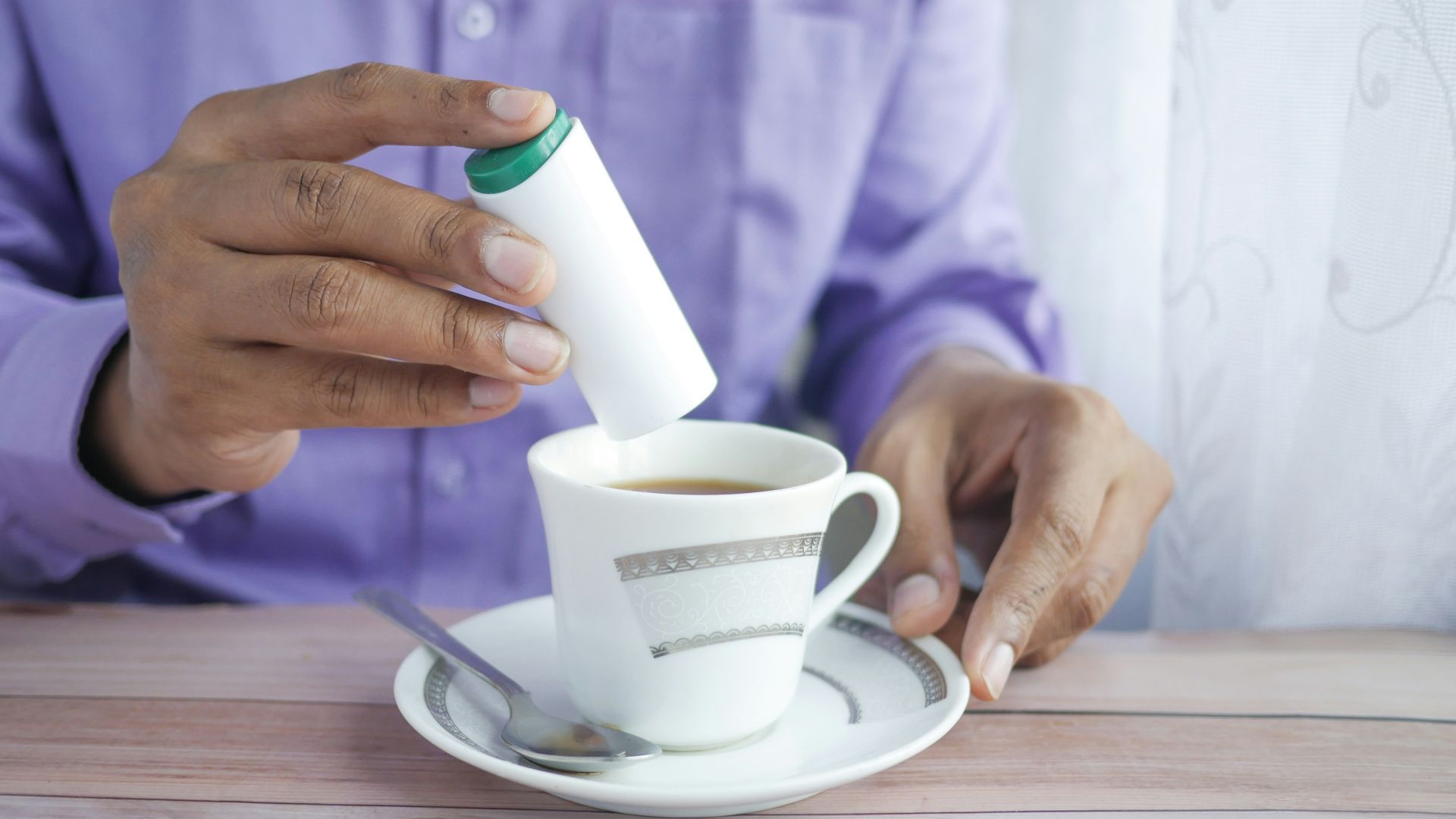 person holding white ceramic mug