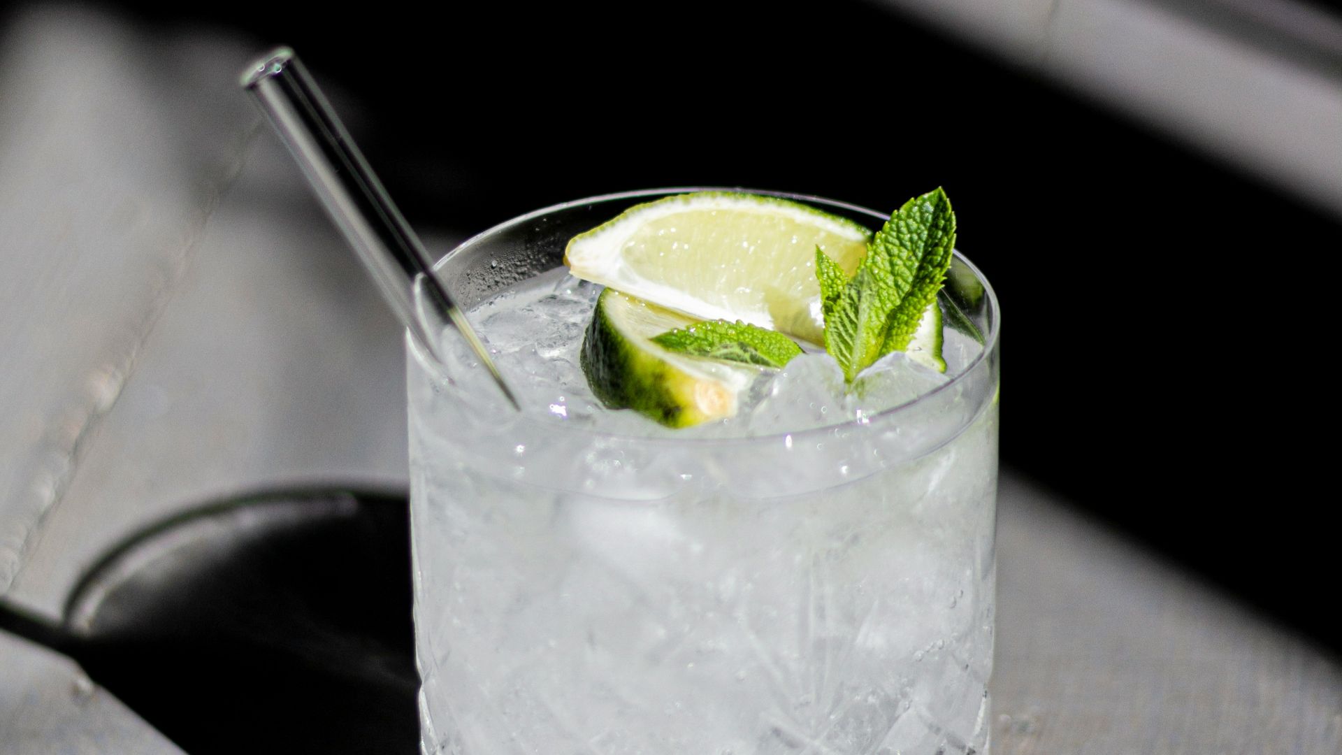 clear drinking glass with ice and lime