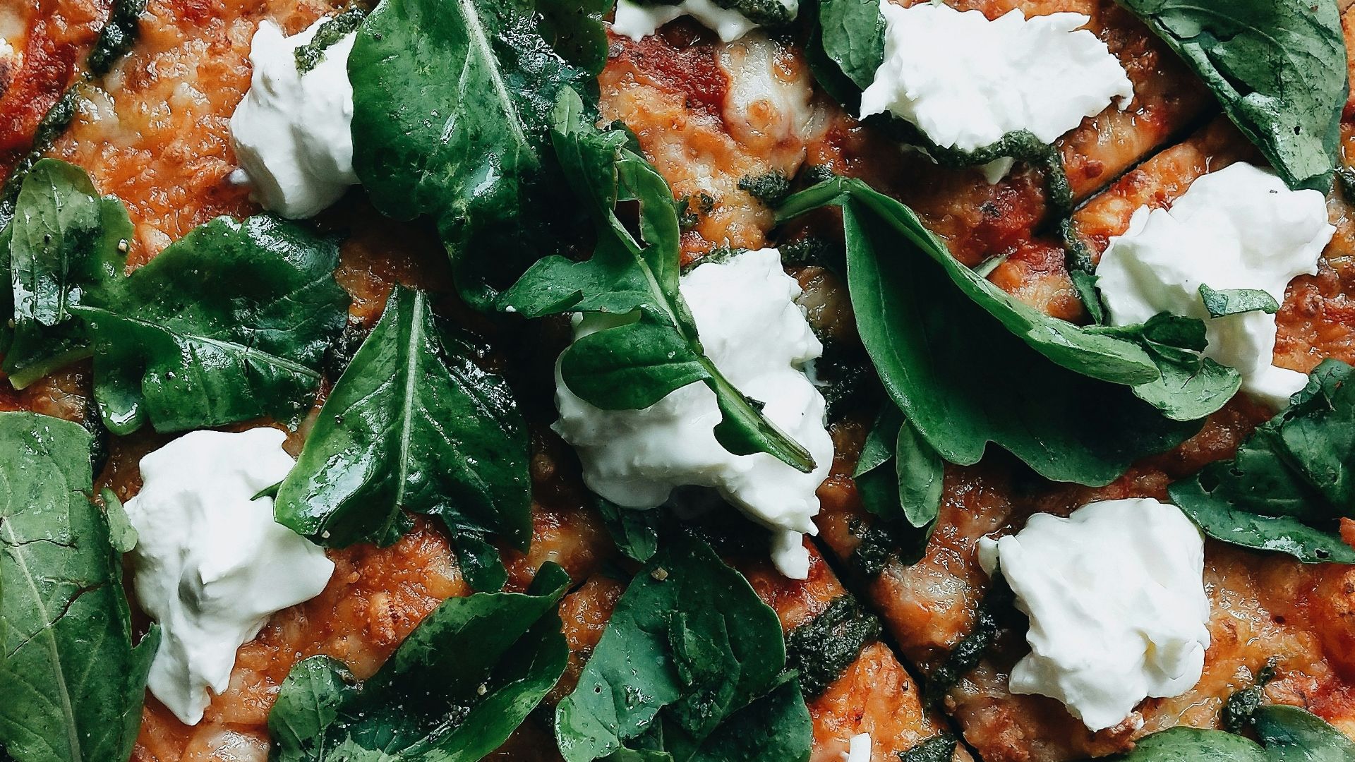 pizza with green leaves on top