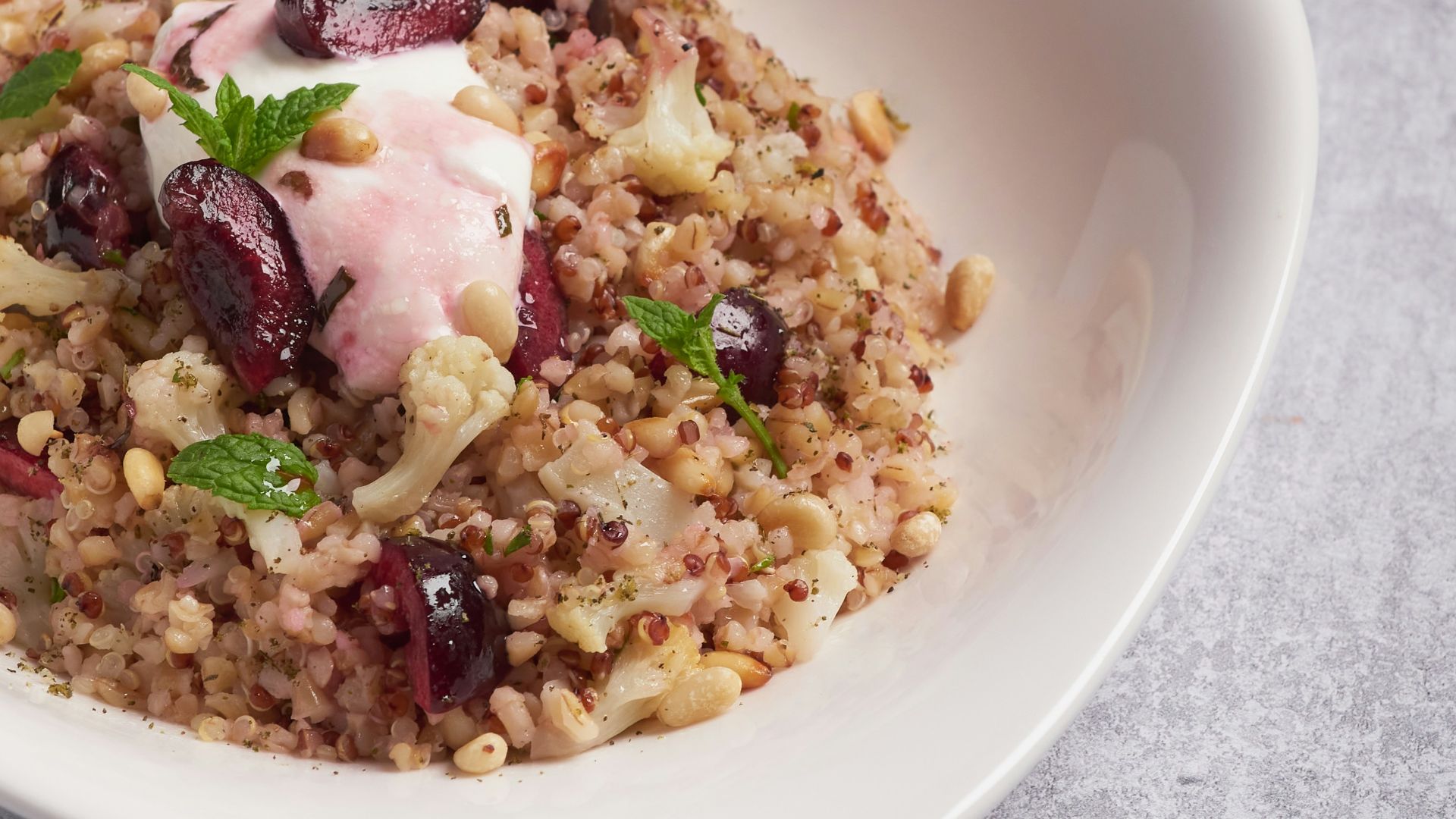 a white bowl filled with food on top of a table