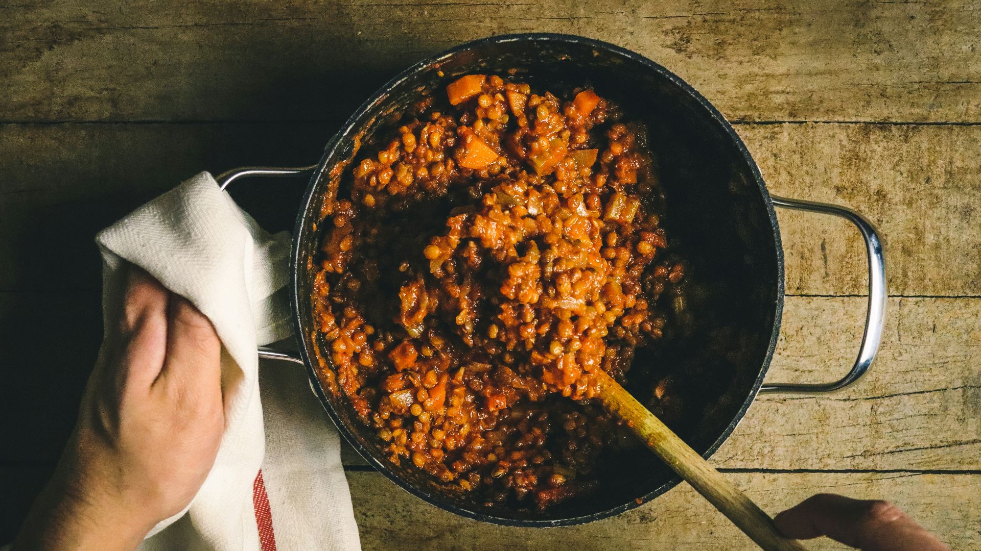person holding stainless steel round tray with food