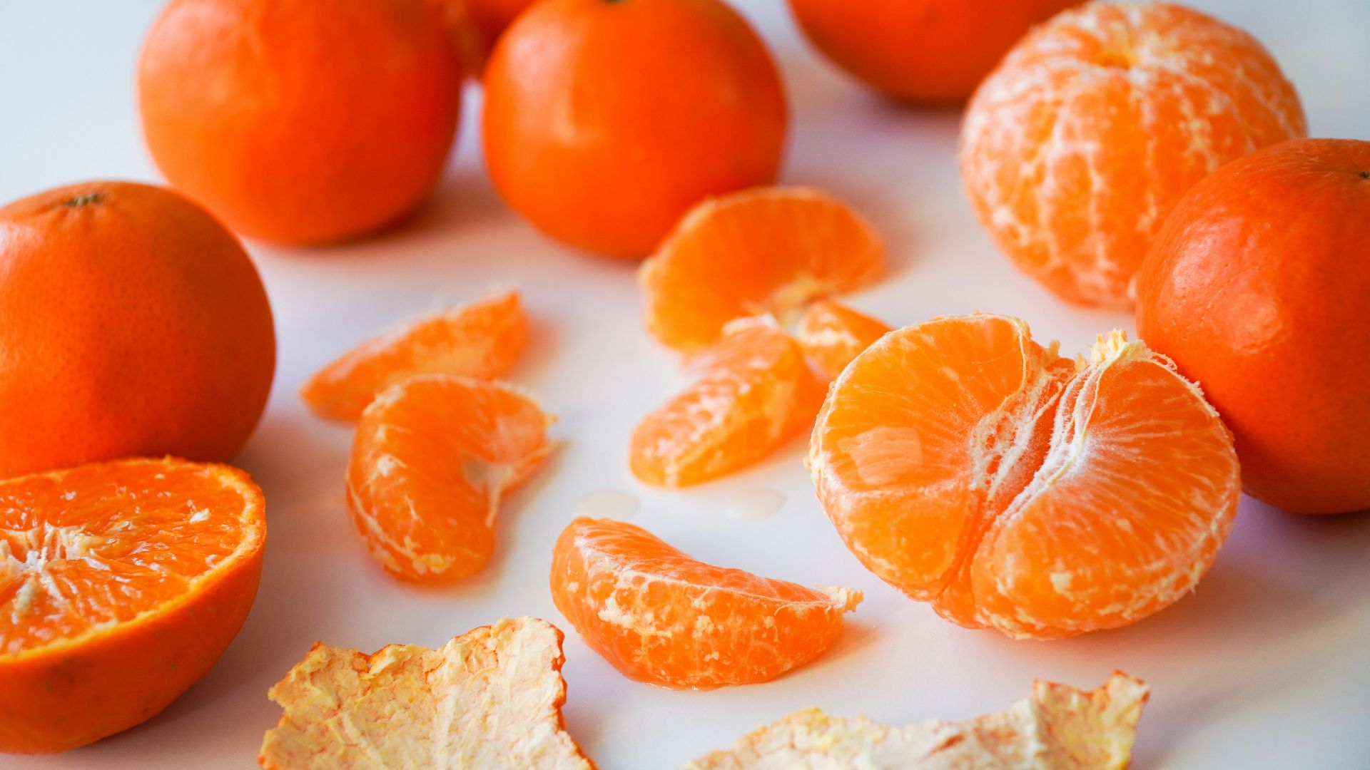 sliced orange fruits on white ceramic plate