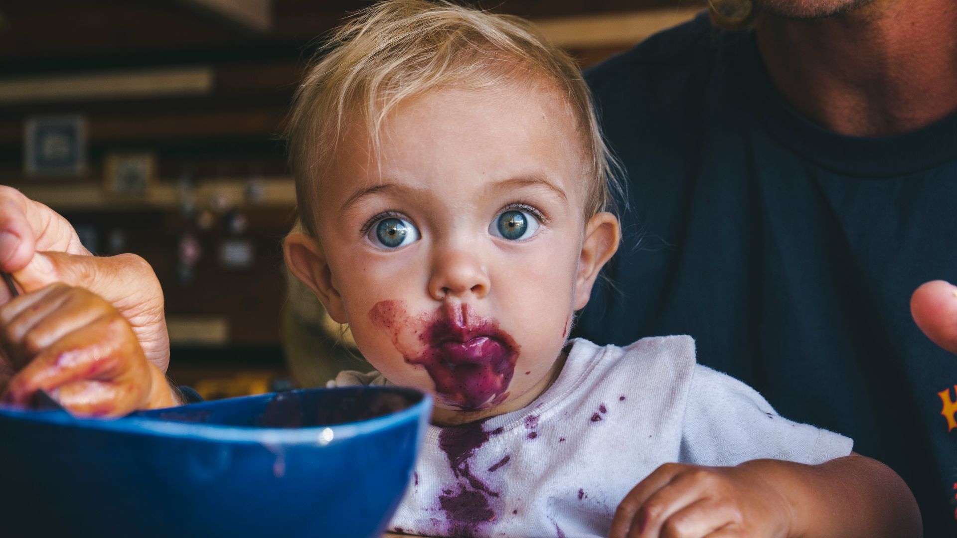 a little girl with food all over her face