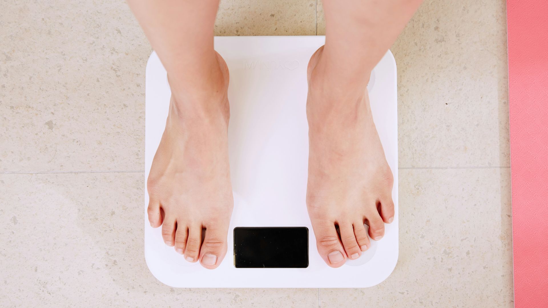 person standing on white digital bathroom scale