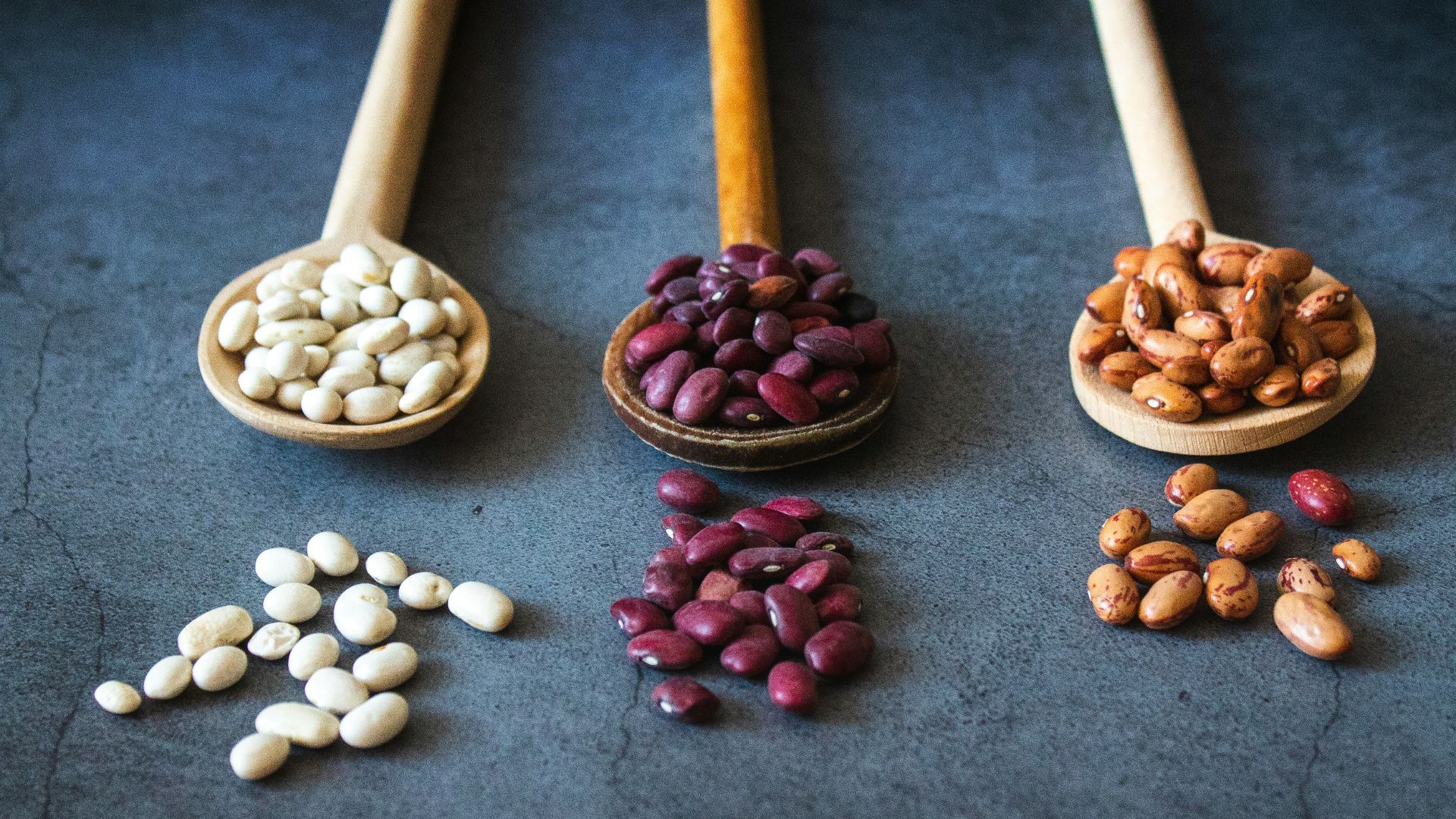 brown wooden spoon with red and brown beans