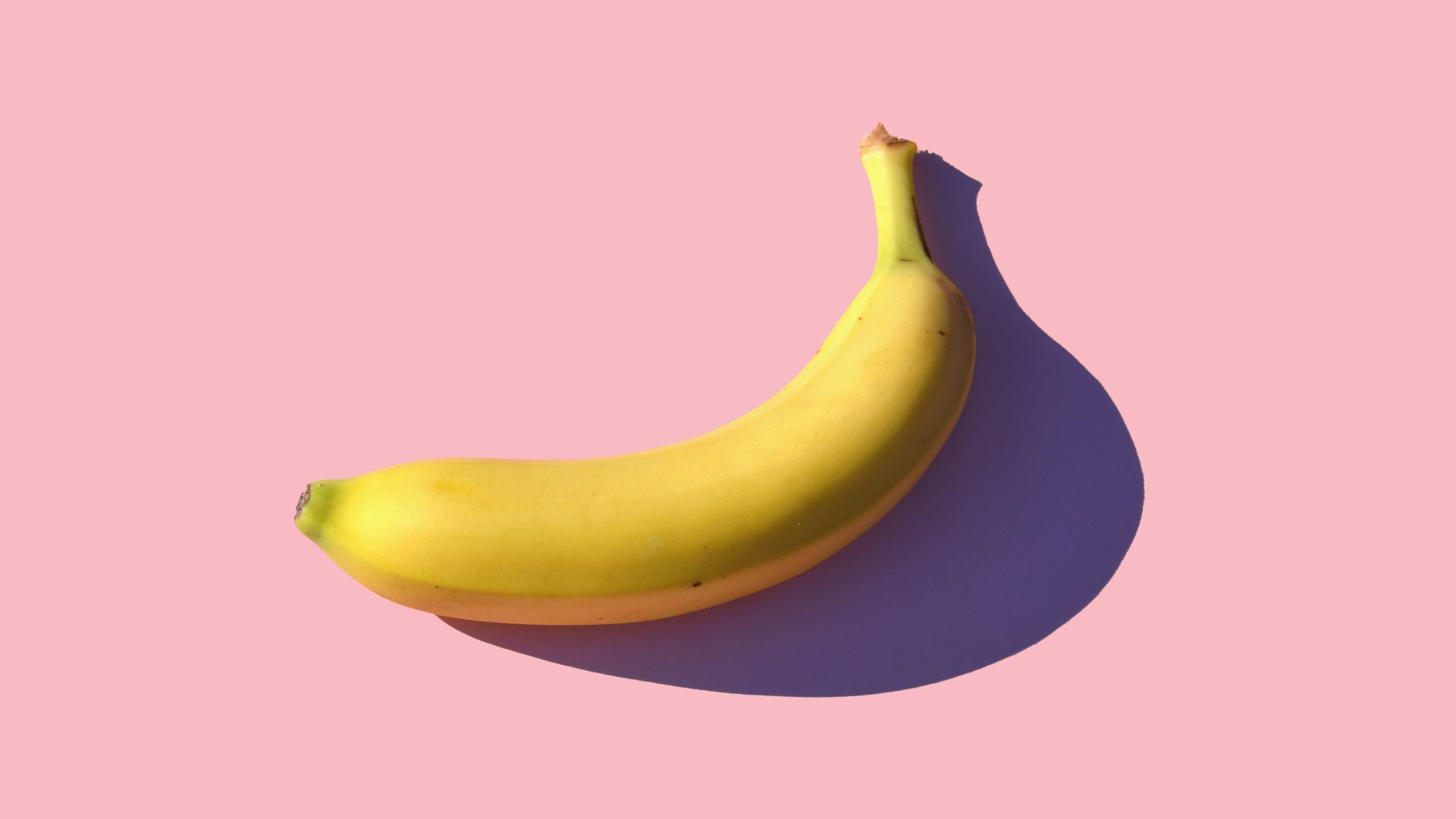 riped banana on pink surface