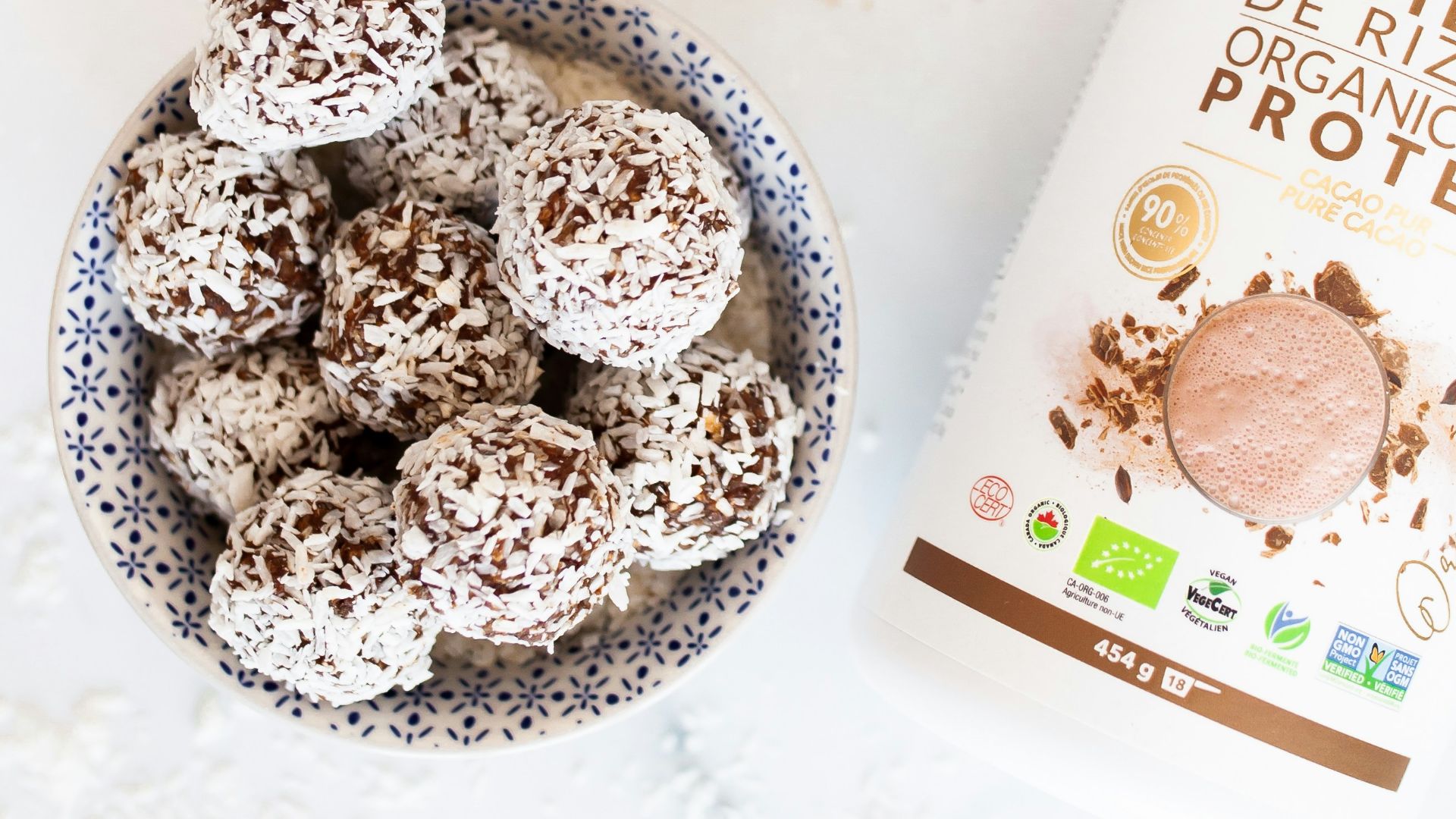 a bowl of protein powder next to a container of protein powder