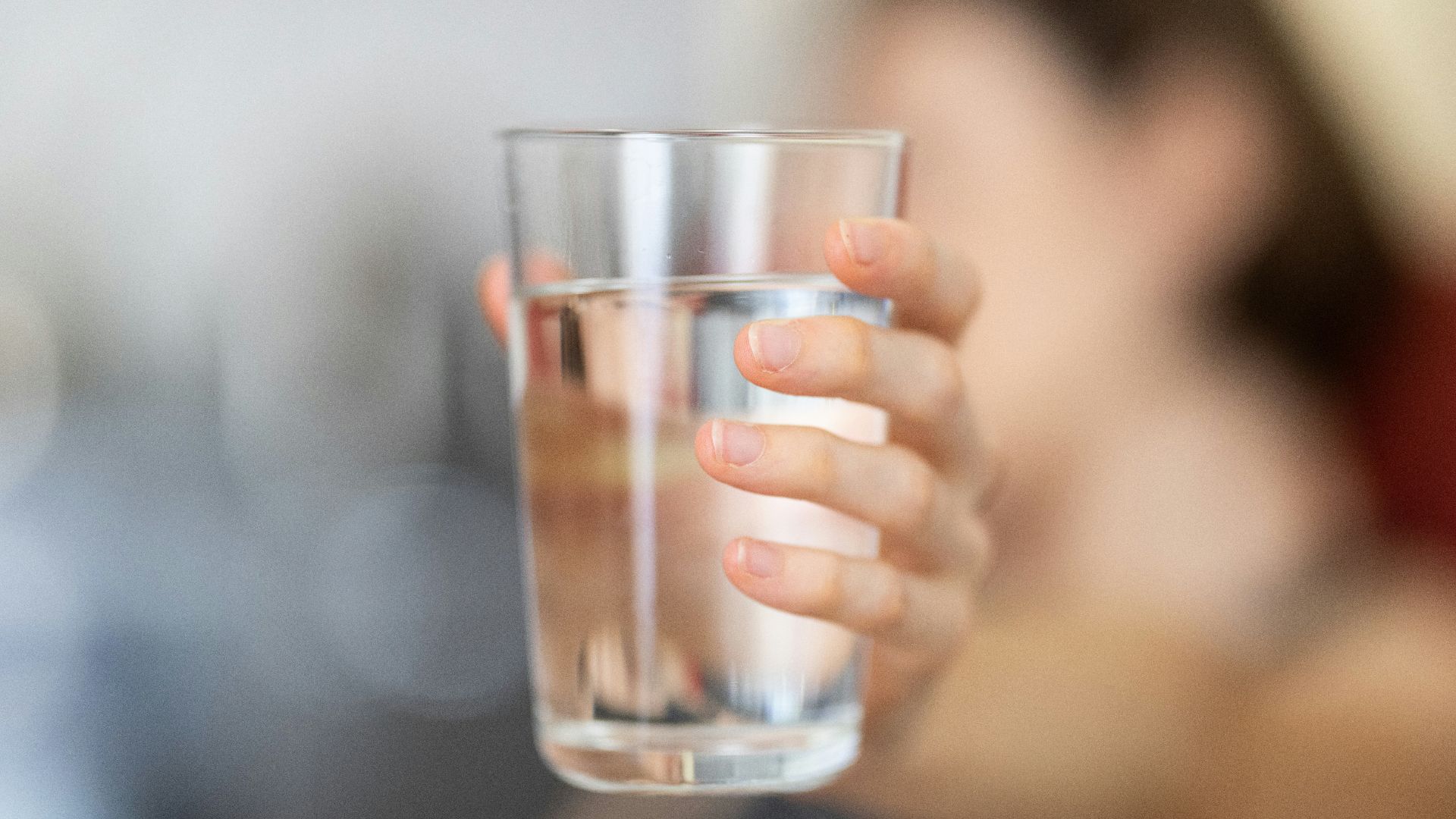 person holding clear drinking glass