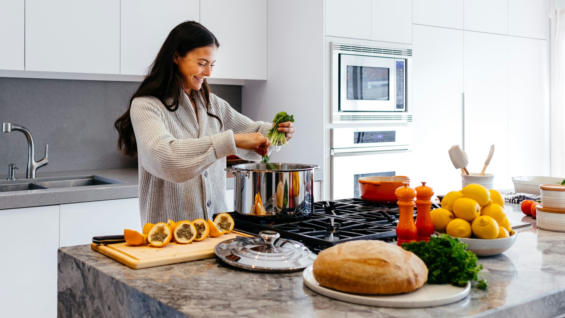 woman smiling while cooking