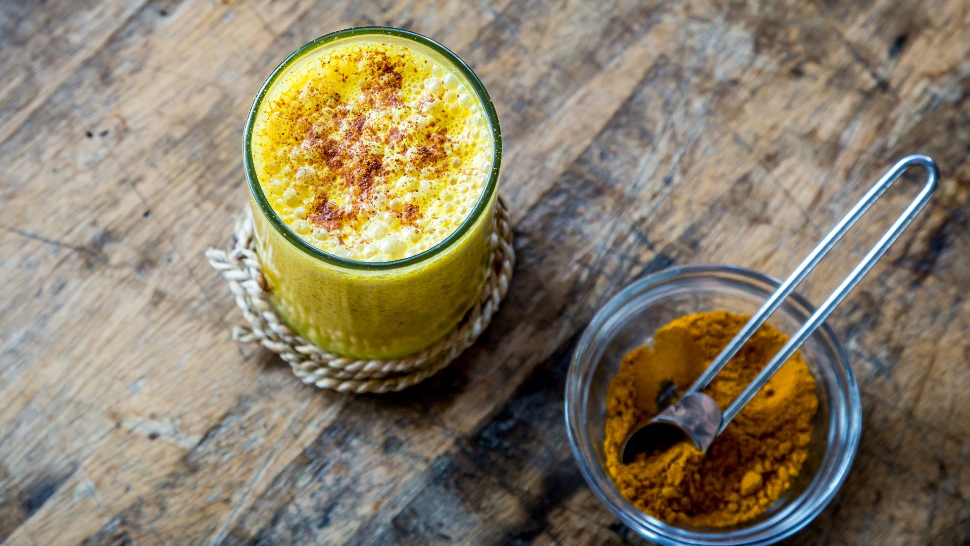 clear drinking glass full of orange liquid