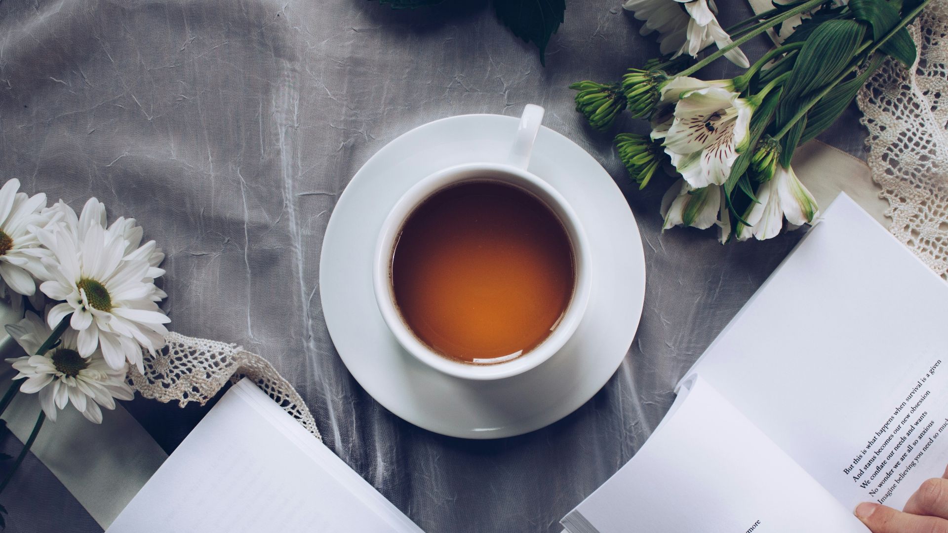 white cup with saucer near bok