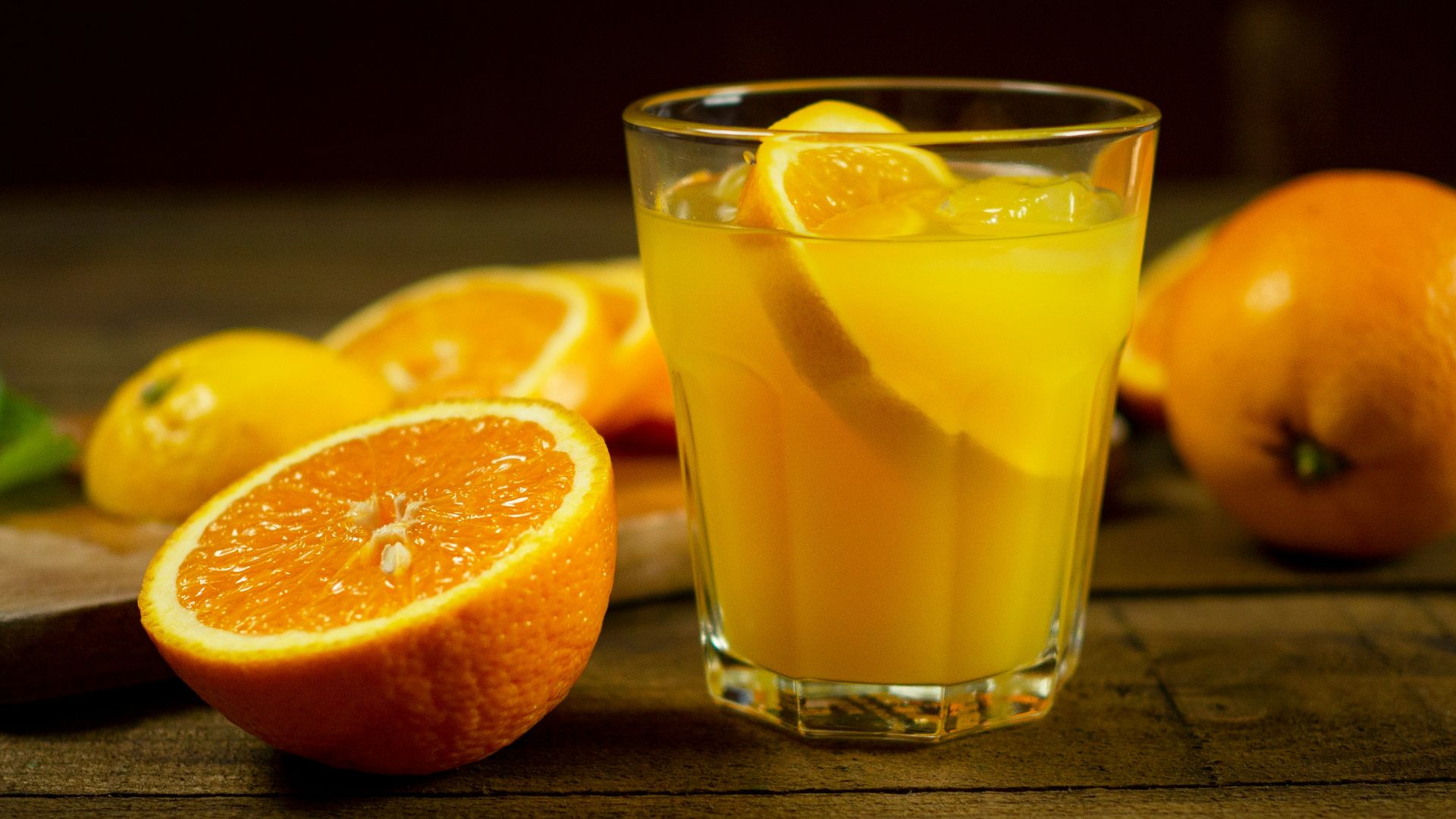 orange juice in clear drinking glass