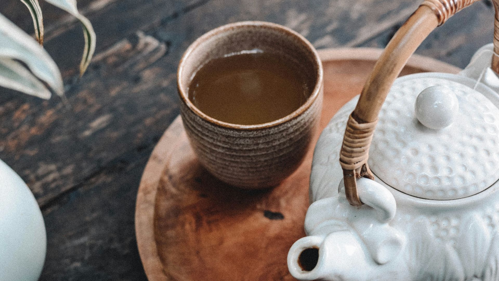 white and brown ceramic teapot on wooden tray