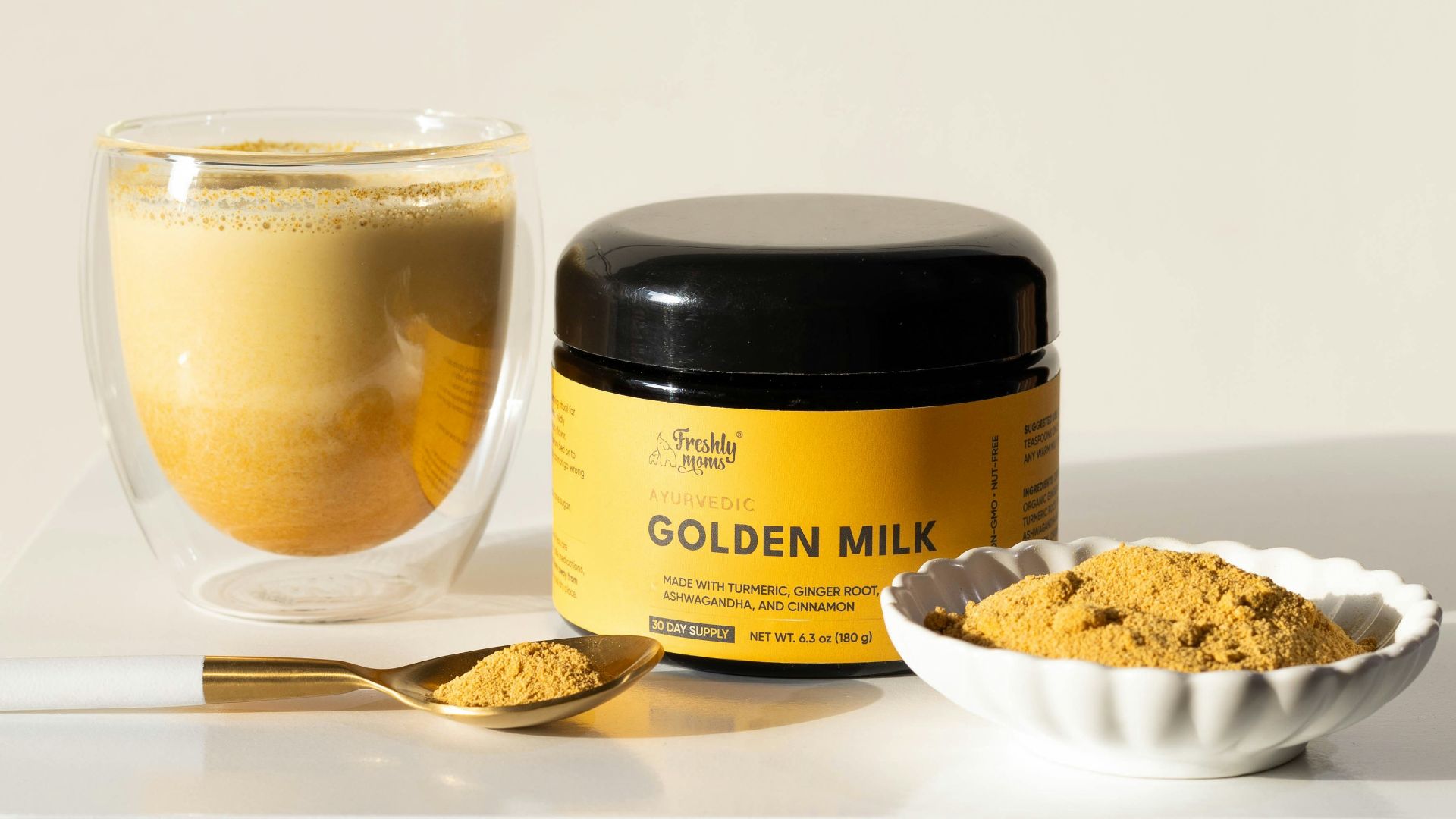 a table with a bowl of powder and a cup of coffee