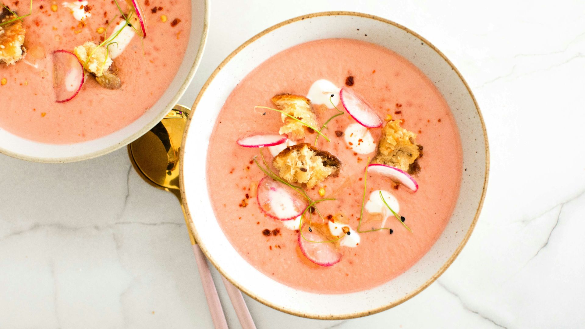 a bowl of soup with chopsticks
