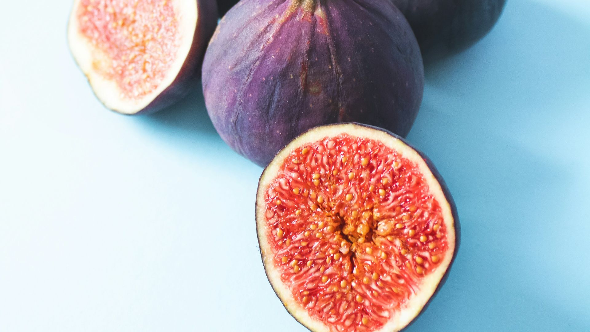 2 round black and red fruits