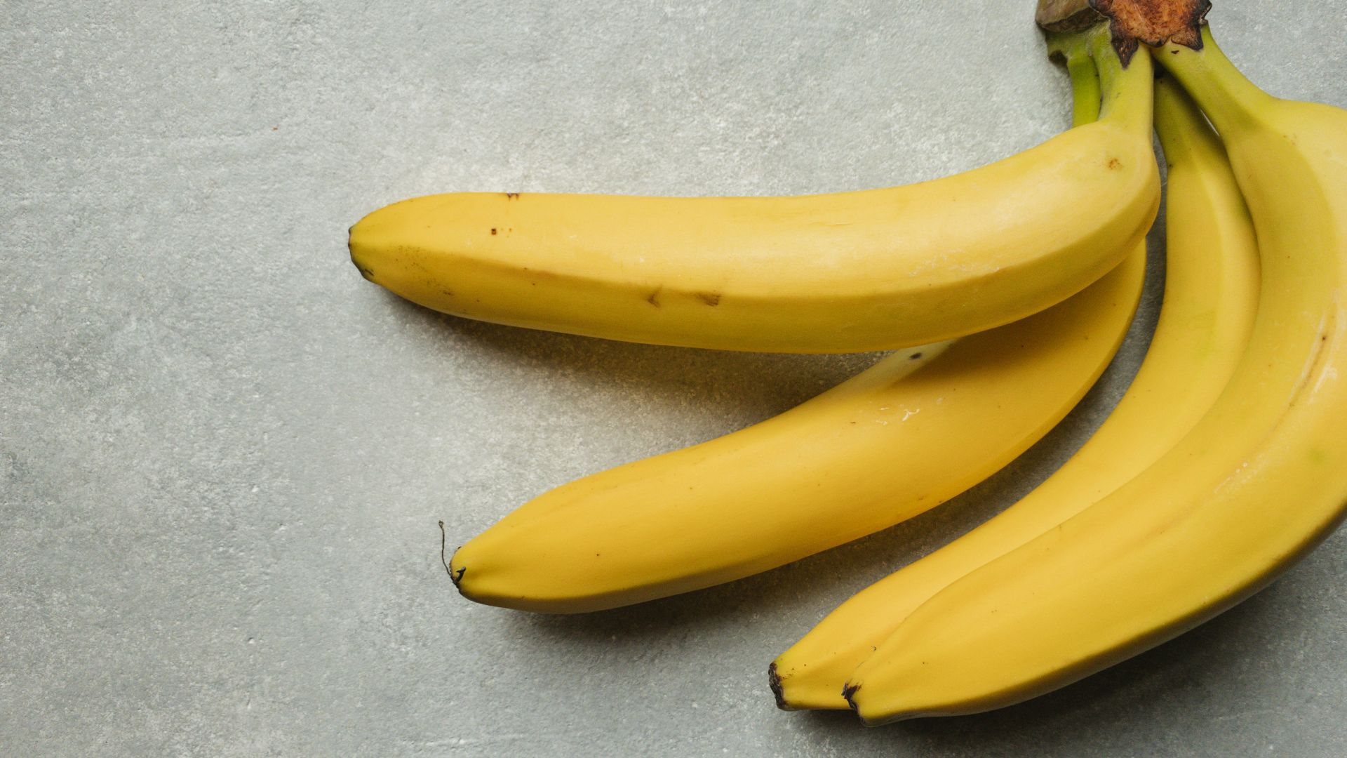 yellow banana fruit on gray table